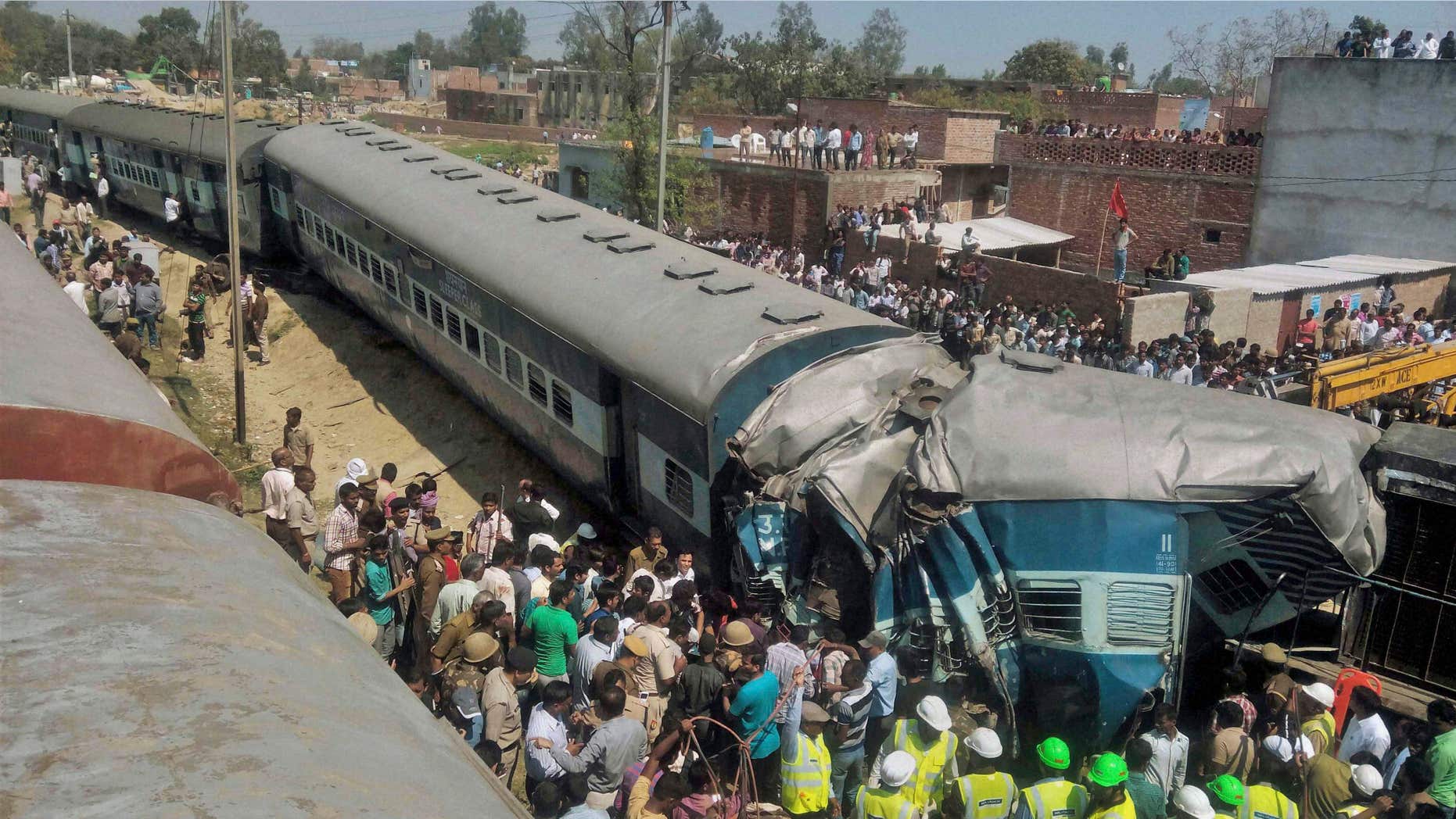 MArch 20, 2015: Indian rescue workers gather at the site of a train accident near Bachhrawan village in Uttar Pradesh state, India.