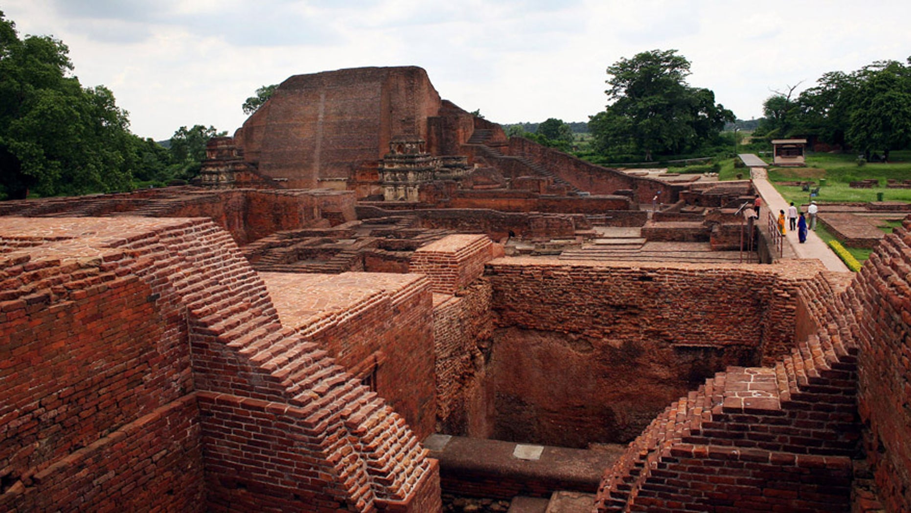 In this July 5, 2006 file photo, tourists walk at the ruins of the Nalanda University at Nalanda, India. UNESCO has put four new sites on its World Heritage List, including the archaeological site of Nalanda Mahavihara, or Nalanda University, on Friday, July 15, 2016.