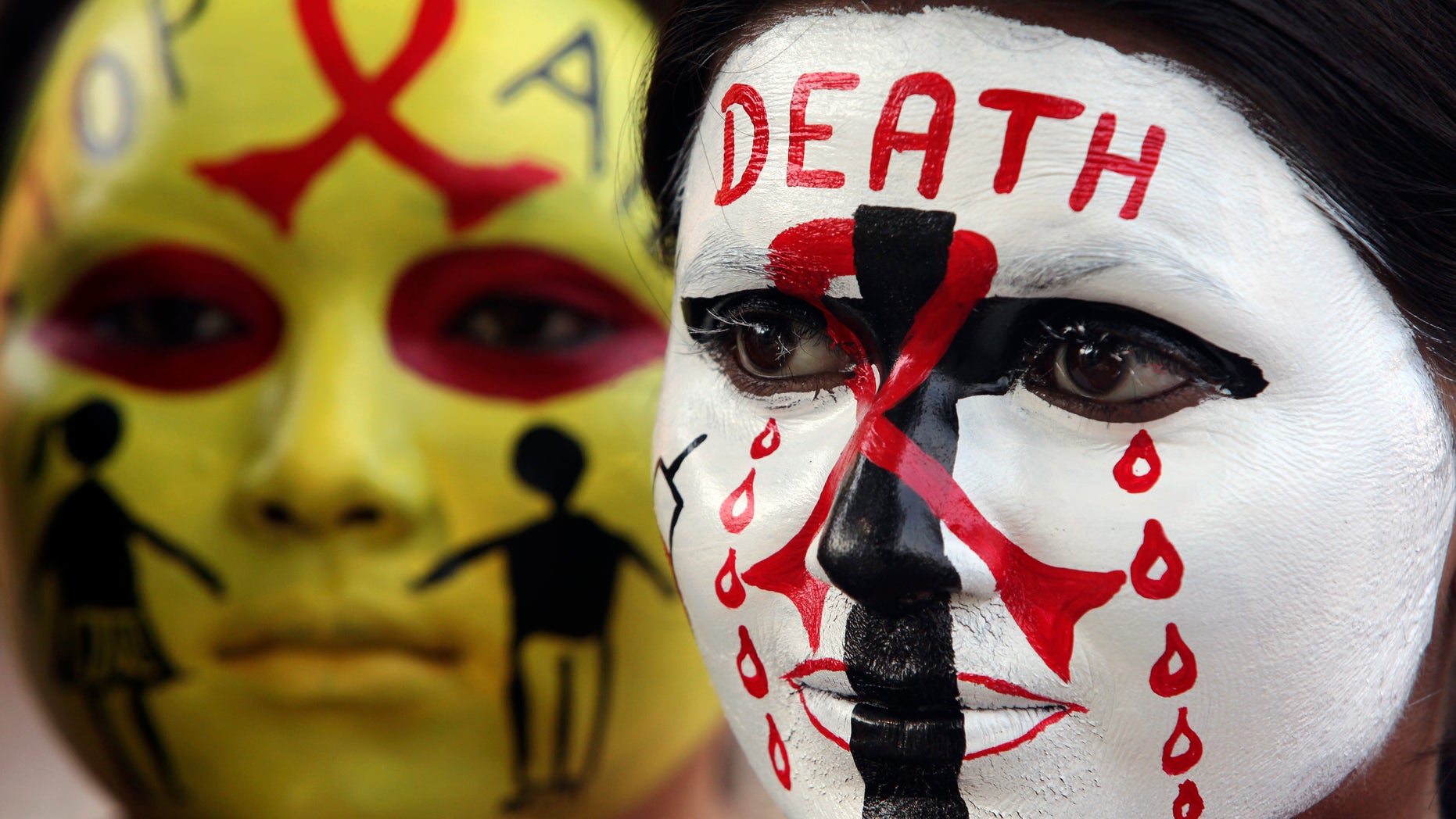 Volunteers of National Service Scheme (NSS) pose with HIV/AIDS awareness messages on their faces during a face painting competition ahead of the World AIDS Day in the northern Indian city of Chandigarh November 29, 2014. World AIDS Day is observed on December 1 every year. REUTERS/Ajay Verma
