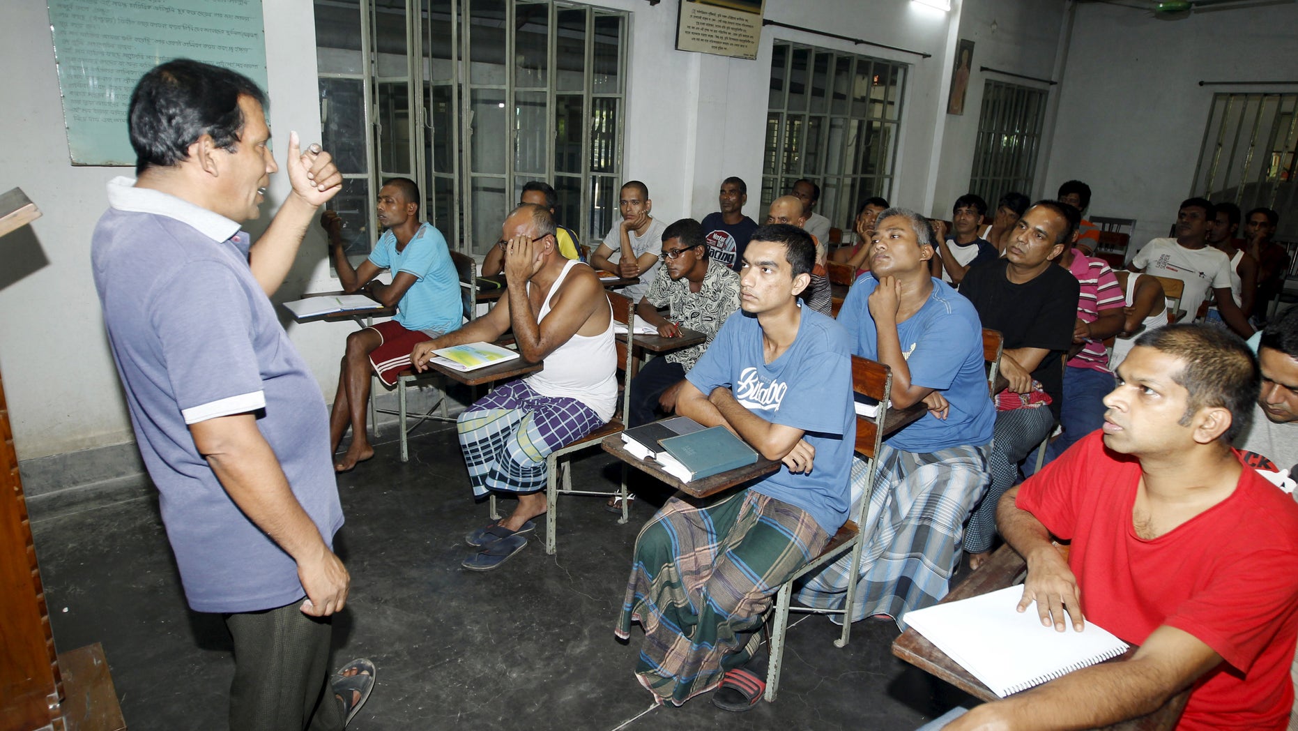 A councillor (L) talks to drug addicts in a classroom at the Bangladesh Rehabilitation and Assistance Centre for Addicts (BARACA) in Dhaka September 12, 2015. REUTERS/Ashikur Rahman