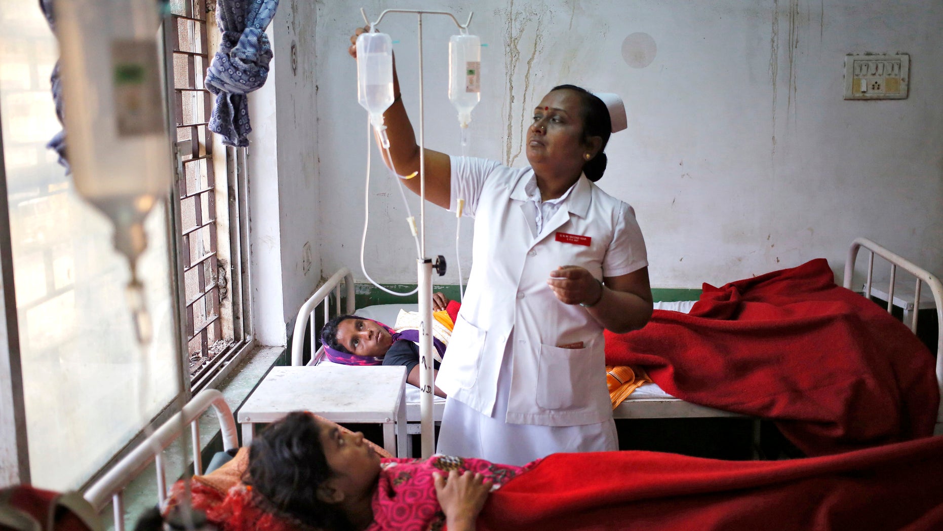 A nurse tends to a woman, who underwent a sterilization surgery at a government mass sterilization "camp" at Chhattisgarh Institute of Medical Sciences (CIMS) hospital in Bilaspur, in the eastern Indian state of Chhattisgarh, November 13, 2014. The doctor whose sterilization of 83 women in less than three hours ended in at least a dozen deaths said the express operations were his moral responsibility and blamed adulterated medicines for the tragedy. REUTERS/Anindito Mukherjee