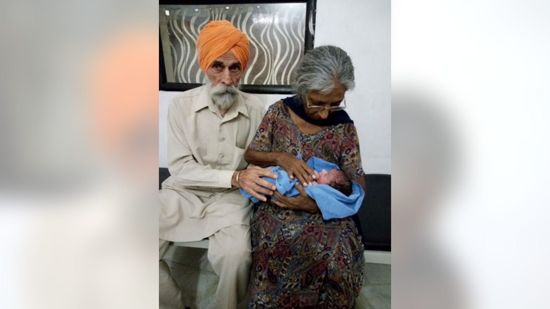 A man carries a newborn baby at a hospital in this file photo.