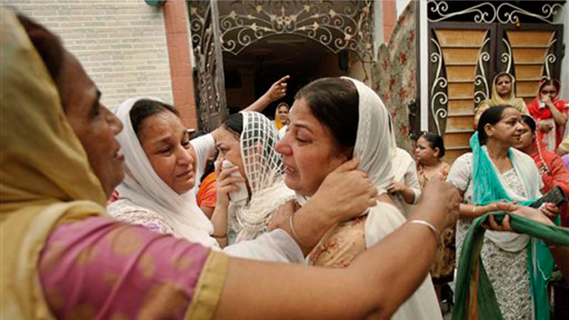 Relatives of blast victim Inder Singh mourn as his body is taken for cremation in New Delhi, India, Thursday, Sept. 8, 2011.