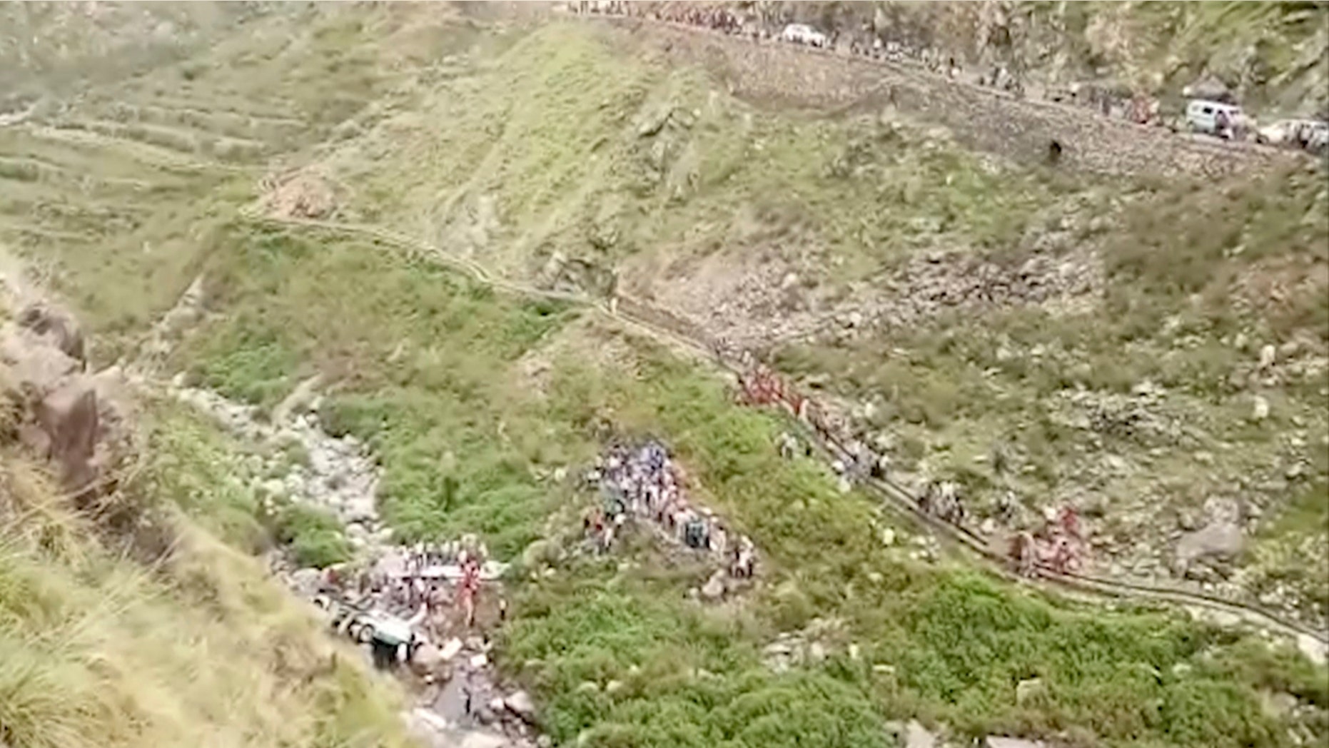 In this grab made from video provided by KK Productions, shows the area of a deadly bus accident in Uttarakhand's Paudi Garhwal district, northern India, Sunday, July 1, 2018. Chief Minister of Uttarakhand state Trivendra Rawat said the bus fell into a 700-foot (213-meter) deep gorge in the Himalayan foothills. (KK Production via AP)
