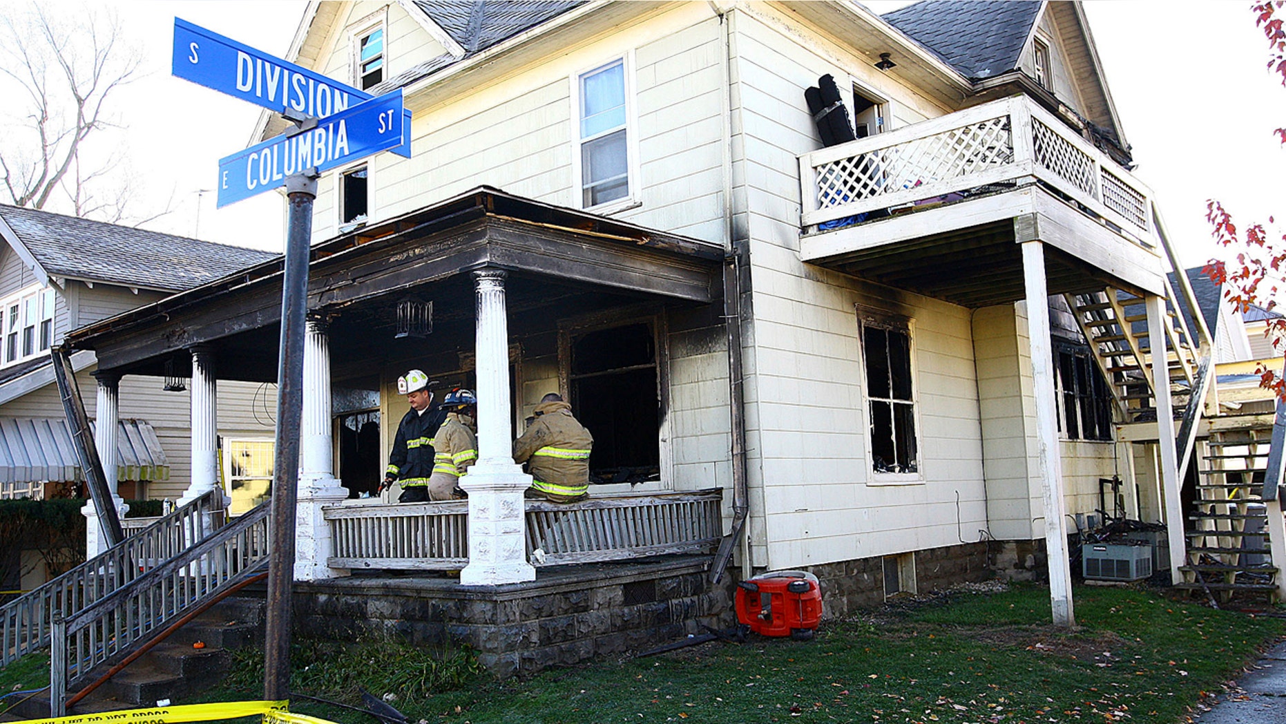 Firefighters work at a house where four children died in a house fire in the 100 block of East Columbia Street in Flora, Ind., on Monday morning, Nov. 21, 2016.
