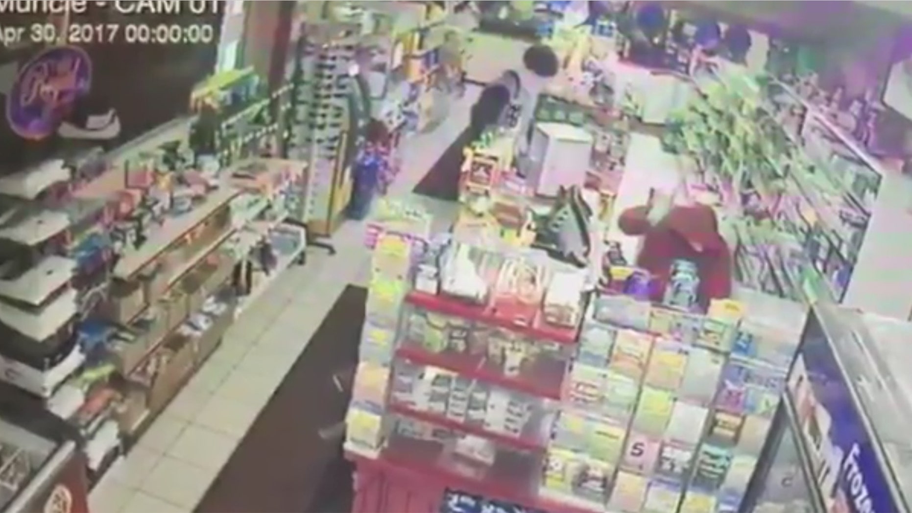 A suspect is seen beating a convenience store clerk in Muncie, Ind.