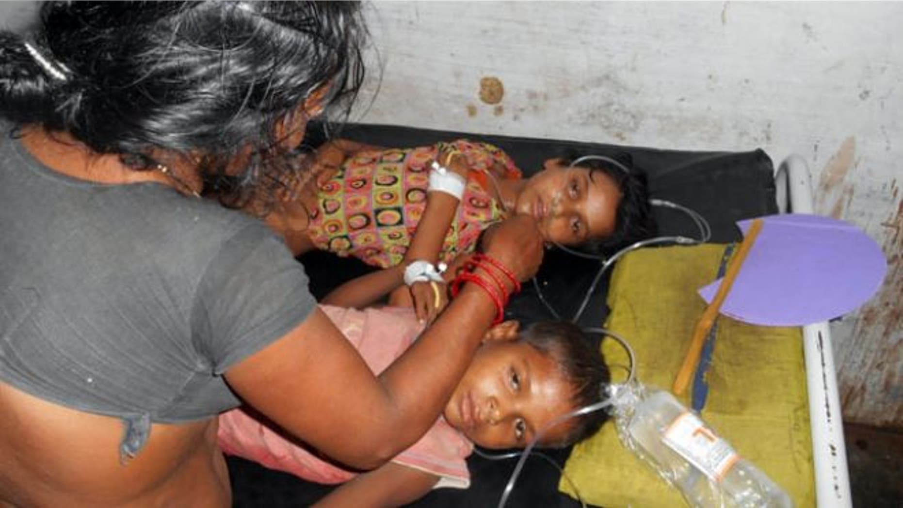 July 16, 2013: Schoolchildren receive treatment at a hospital after falling ill soon after eating a free meal at a primary school in Chhapra district, in the eastern Indian state of Bihar.