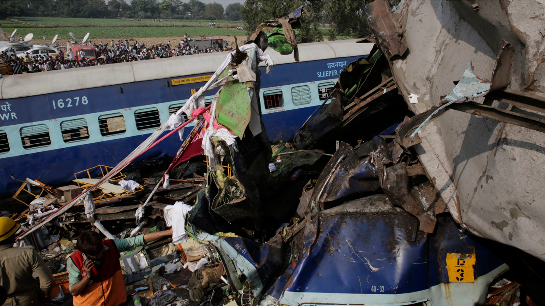 Rescuers work on the site of a train derailment accident in Kanpur Dehat, India, Sunday, Nov. 20, 2016.