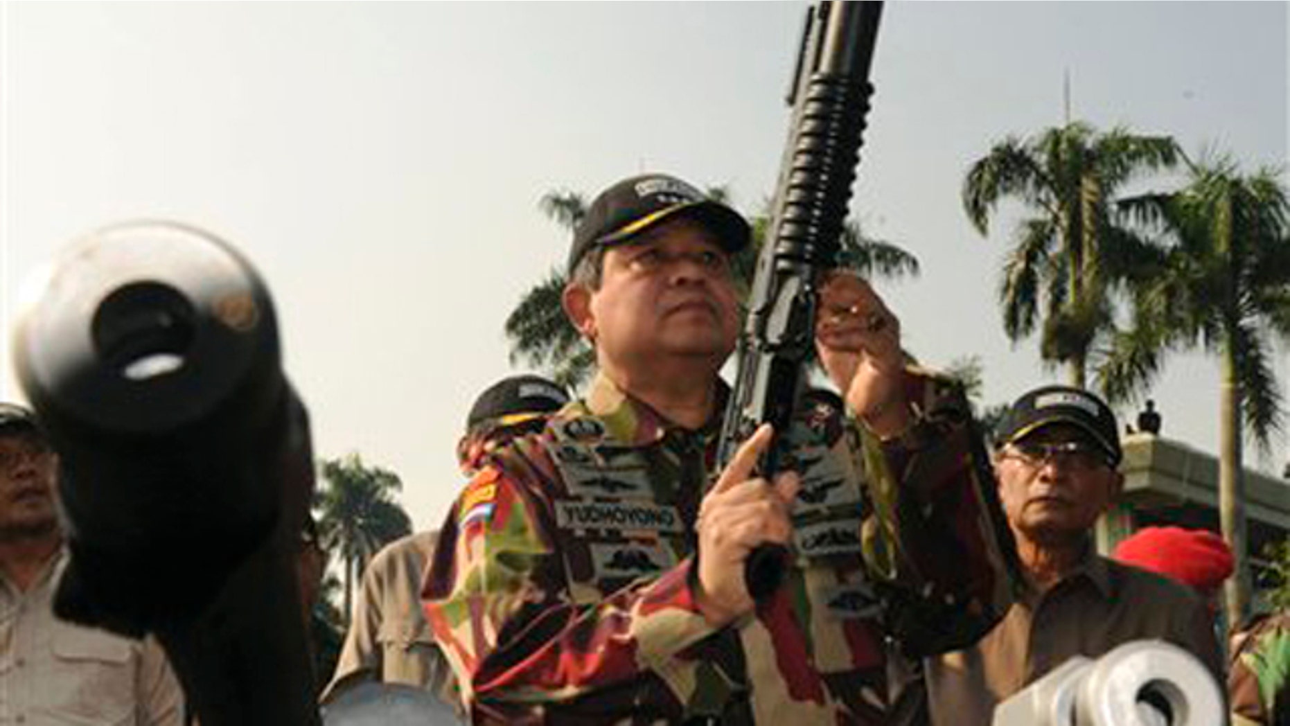 In this Aug. 20, 2009, file photo released by Indonesian Presidential Office, Indonesian President Susilo Bambang Yudhoyono, center, inspects an assault rifle during his visit to Special Forces Commandos (KOPASSUS) headquarters in Jakarta, Indonesia.