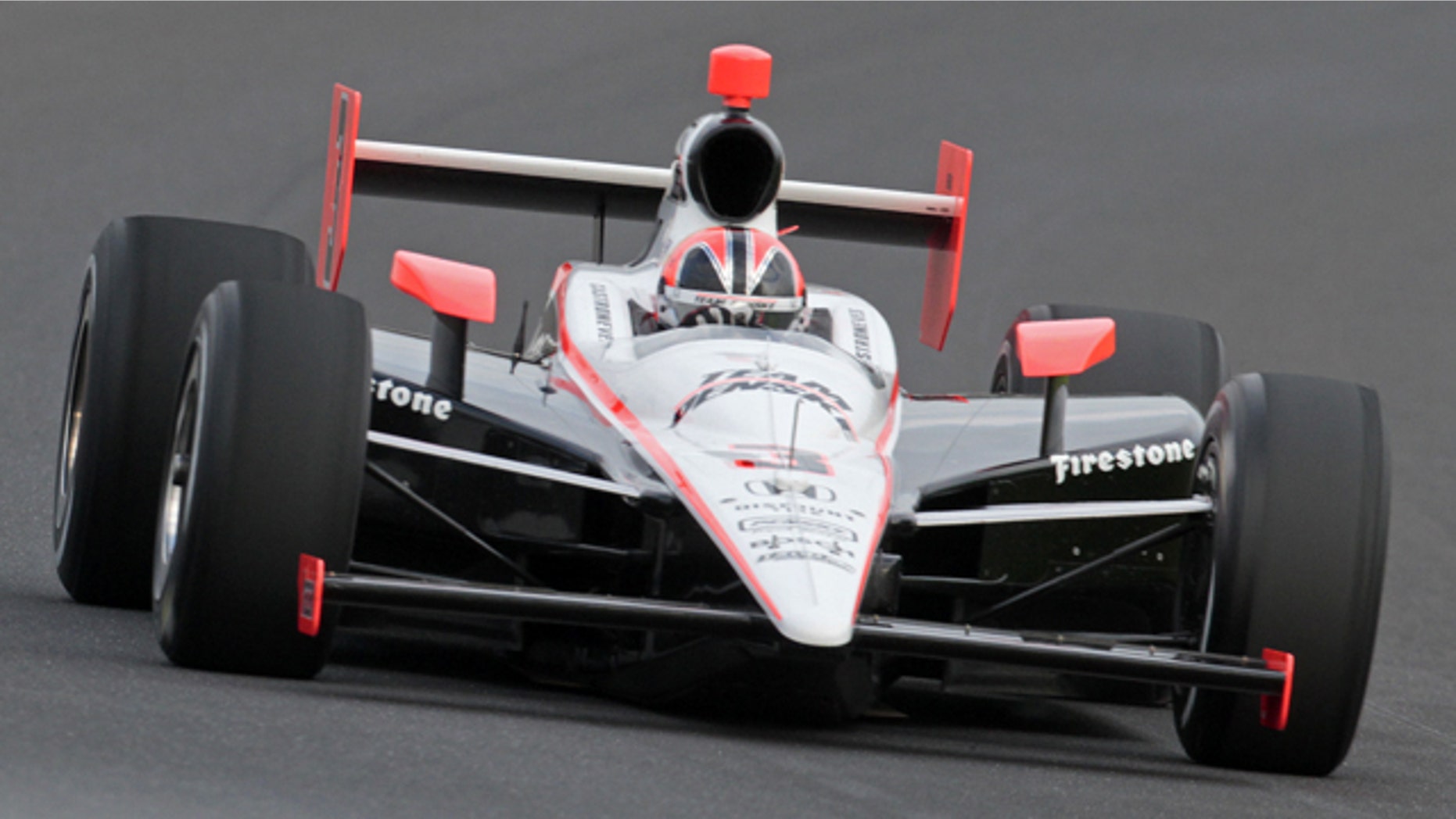 Helio Castroneves makes a qualifying run at the Indianapolis Motor Speedway