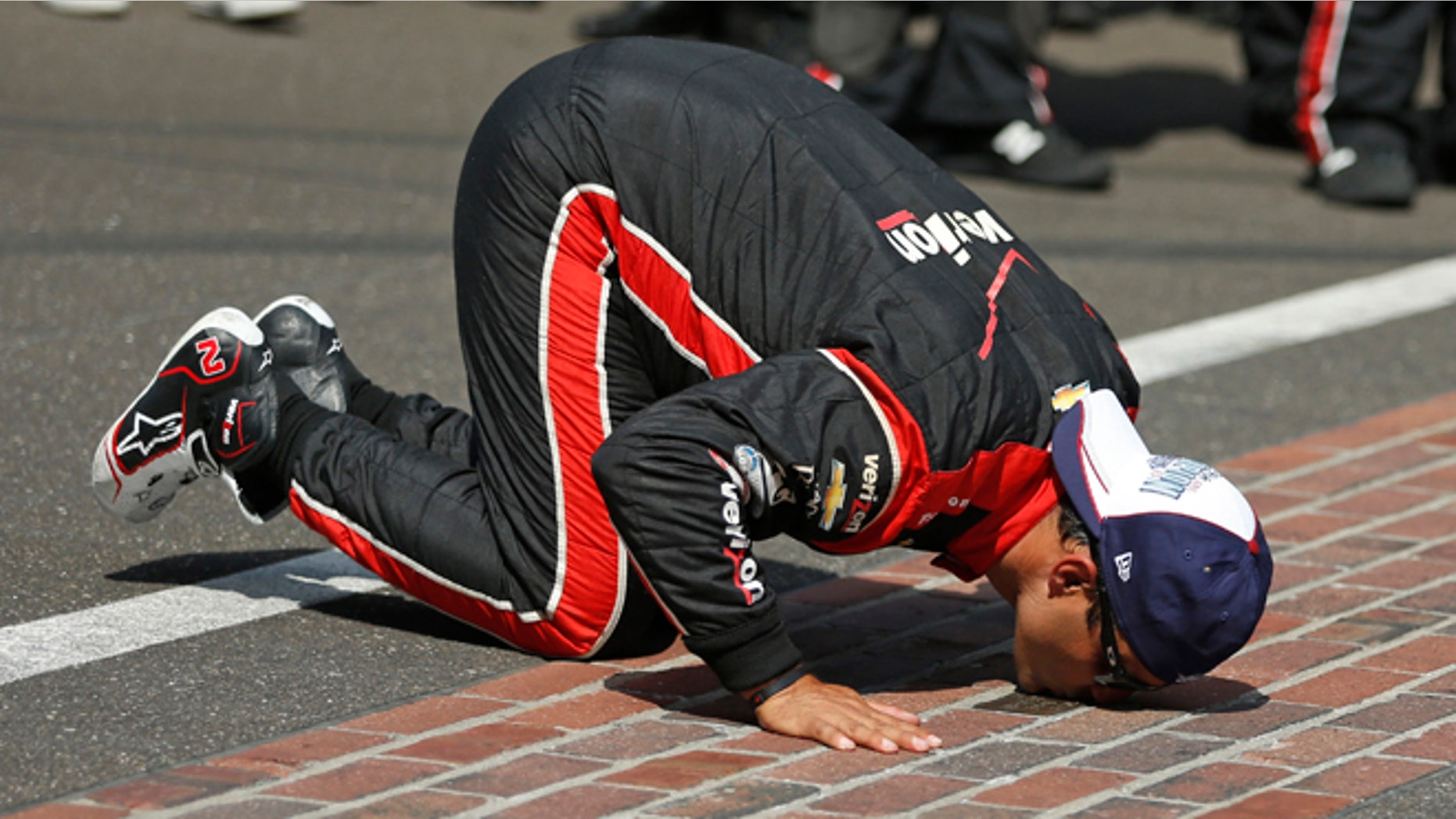 May 24, 2015: Juan Pablo Montoya, of Colombia, kisses the start/finish line after winning the 99th running of the Indianapolis 500 auto race at Indianapolis Motor Speedway in Indianapolis.