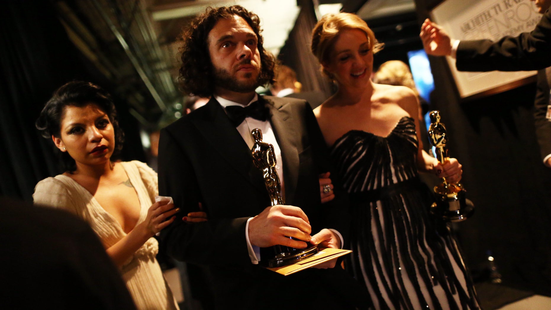 HOLLYWOOD, CA - FEBRUARY 24: (L-R) Artist Inocente Izucar, filmmakers Sean Fine and Andrea Nix Fine, winners of the Best Documentary Short Subject award for 'Inocente,' backstage during the Oscars held at the Dolby Theatre on February 24, 2013 in Hollywood, California. (Photo by Christopher Polk/Getty Images)