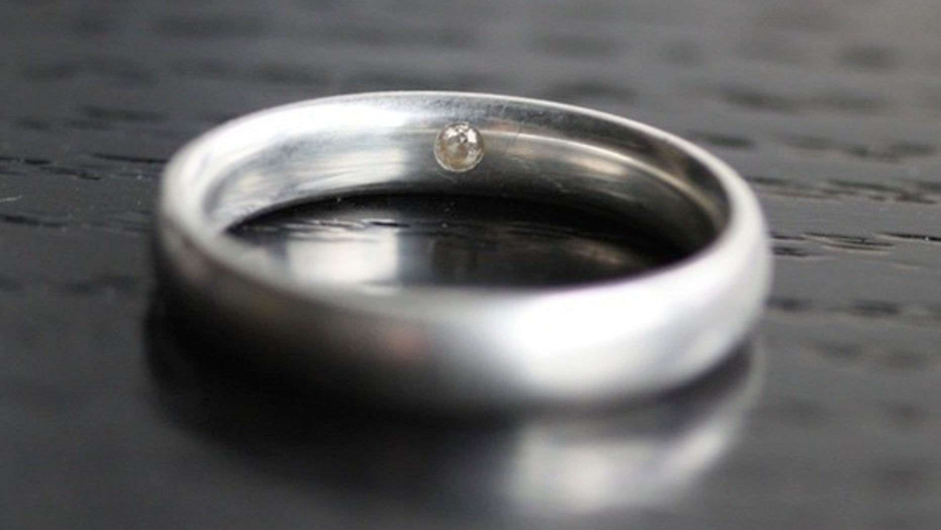 A sterling silver ring that has DNA samples embedded inside (under the diamond).