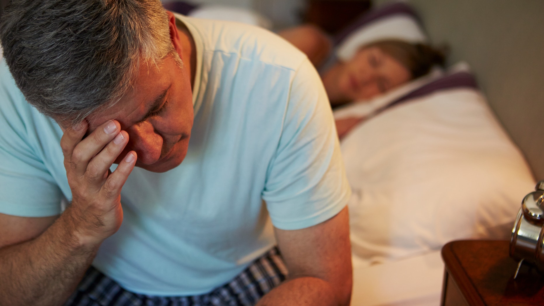 Man Awake In Bed Suffering With Insomnia Late At Night