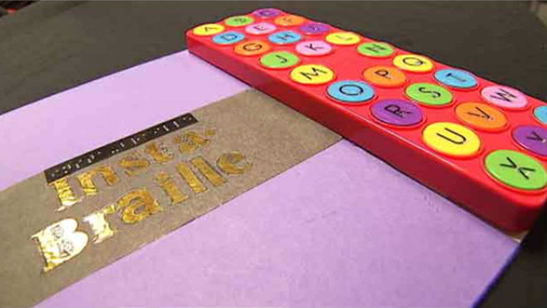 To use the Insta-Braille, a reader feels a Braille character, pushes the button, then hears the word of the alphabet it represents. (image: My Fox Atlanta)