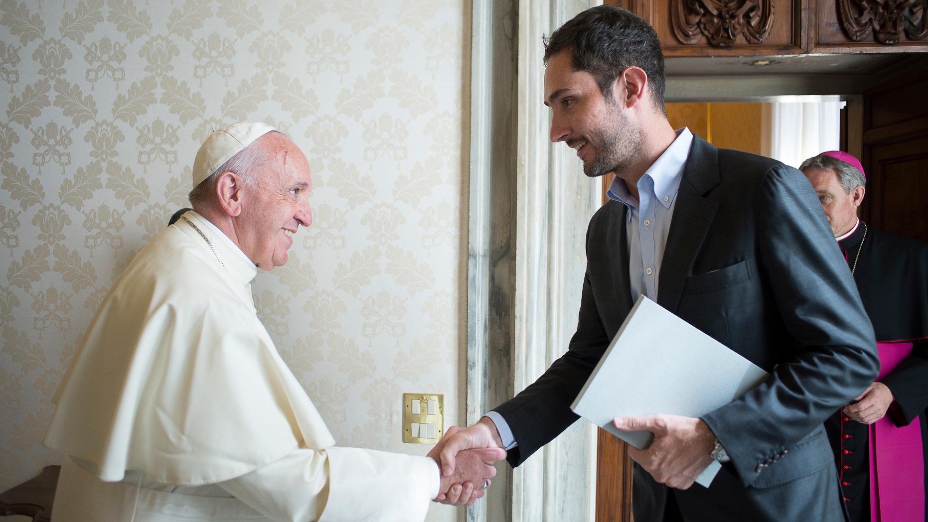 Pope Francis shakes hands with Kevin Systrom, CEO and co-founder of Instagram, during a private audience at the Vatican Friday, Feb. 26, 2016. (L' Osservatore Romano/pool photo via AP)
