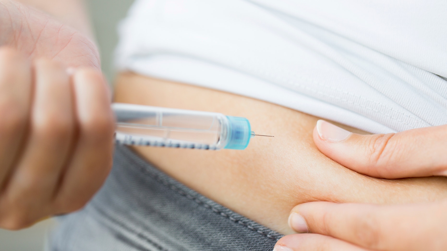 medicine, diabetes, glycemia, health care and people concept - close up of woman hands making injection with insulin pen or syringe