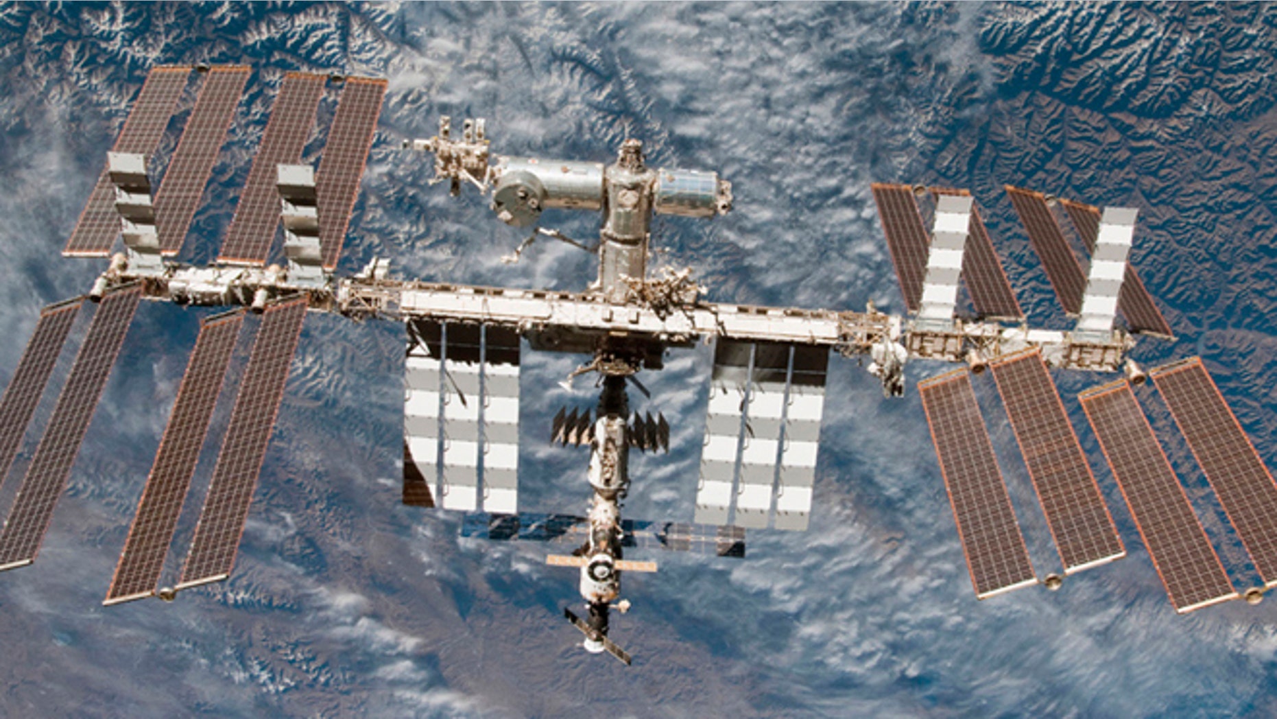 Backdropped by Earth, the International Space Station is seen in this image photographed by an STS-130 crew member on space shuttle Endeavour after the station and shuttle began their post-undocking relative separation, in this undated NASA handout photo.