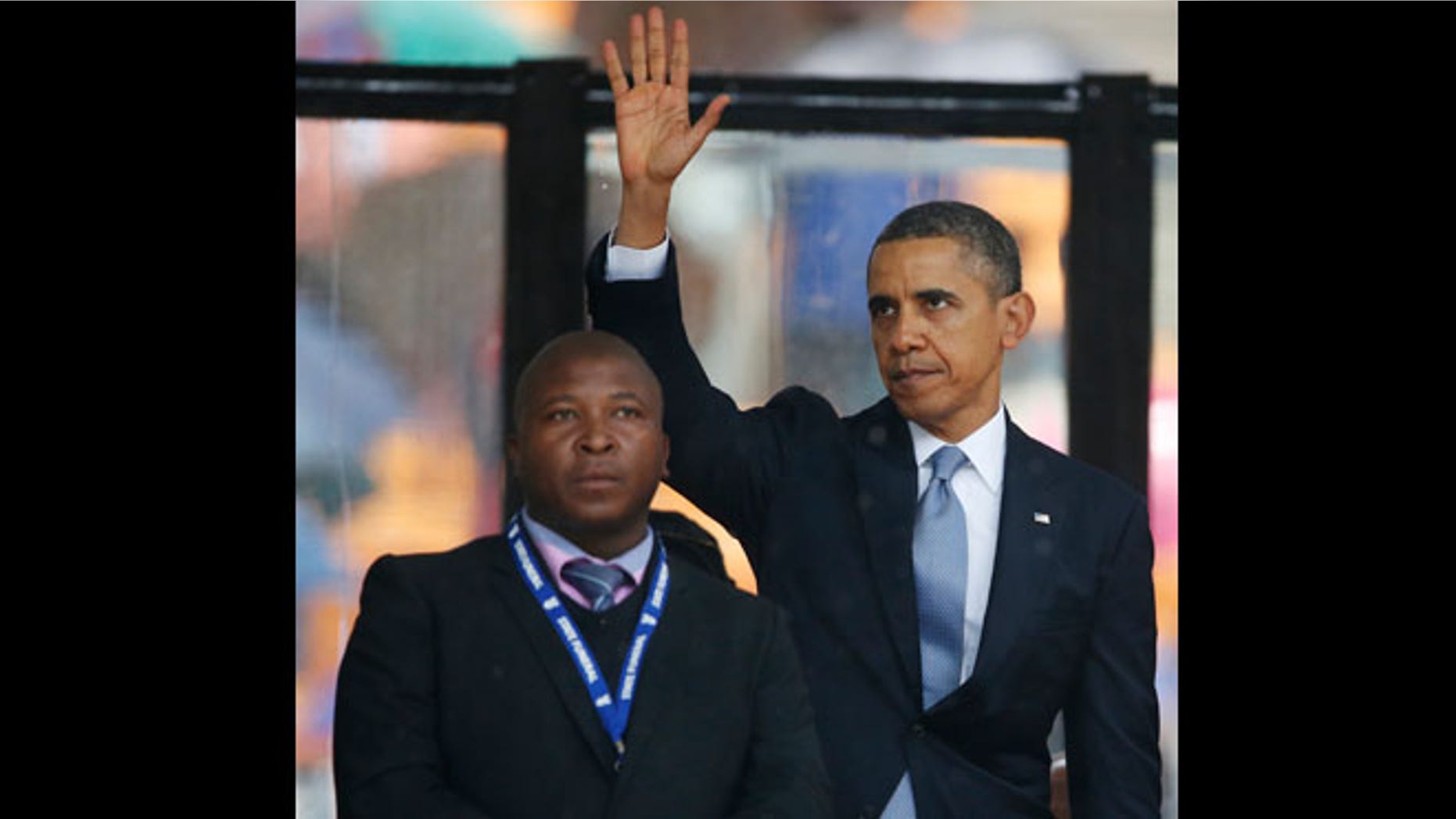 Dec. 10, 2013: President Barack Obama waves standing next to the sign language interpreter after making his speech at the memorial service for former South African president Nelson Mandela at the FNB Stadium in Soweto near Johannesburg. South Africa's deaf federation said on Wednesday that the interpreter on stage for Mandela memorial was a 'fake.'