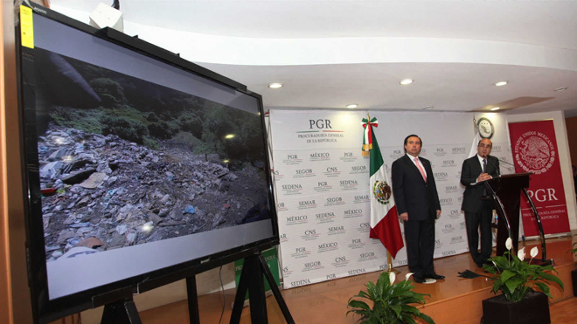 FILE - In this Dec. 7, 2014, file photo, Mexico's Attorney General, Jesus Murillo Karam, right, flanked by Tomas Zeron director of Mexico's Criminal Investigation Agency, speaks during a news conference in Mexico City. The Attorney Generalââ¬â¢s Office has announced on Wednesday, Sept. 14, 2016, the resignation of Tomas Zeron, whose dismissal had been demanded by the families of 43 college students who disappeared two years ago. (AP Photo/Marco Ugarte, File)