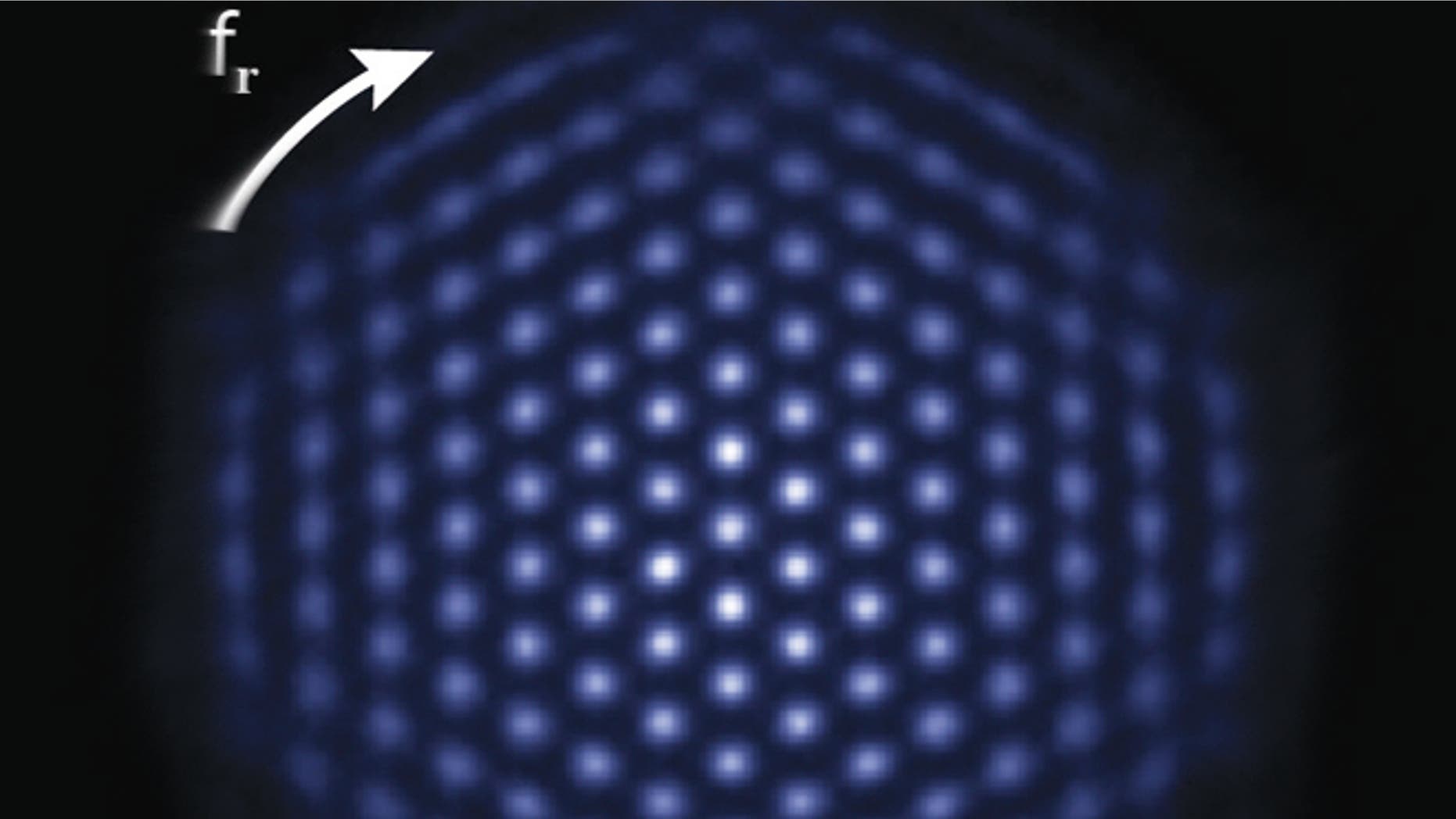 The NIST simulator consists of a tiny, single-plane crystal of hundreds of beryllium ions, less than 1 millimeter in diameter, hovering inside a device called a Penning trap. Here, the ions are glowing, indicating that they are all in the same quantum state. Under the right experimental conditions, the ion crystal spontaneously forms this nearly perfect triangular lattice structure.