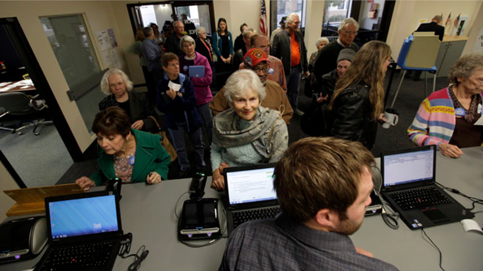 Sept. 27, 2012: Voters wait in line for their ballots during the first day of Iowa early voting at the Polk County Election Office in Des Moines, Iowa.