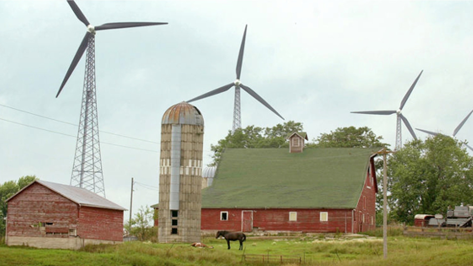 FILE: July 24, 2001: Wind turbines are shown on farmland in Alta, Iowa. An Iowa woman was charged March 3, 2014, in the 1983 killings of her estranged husband and his girlfriend at a horse ranch in Newton.