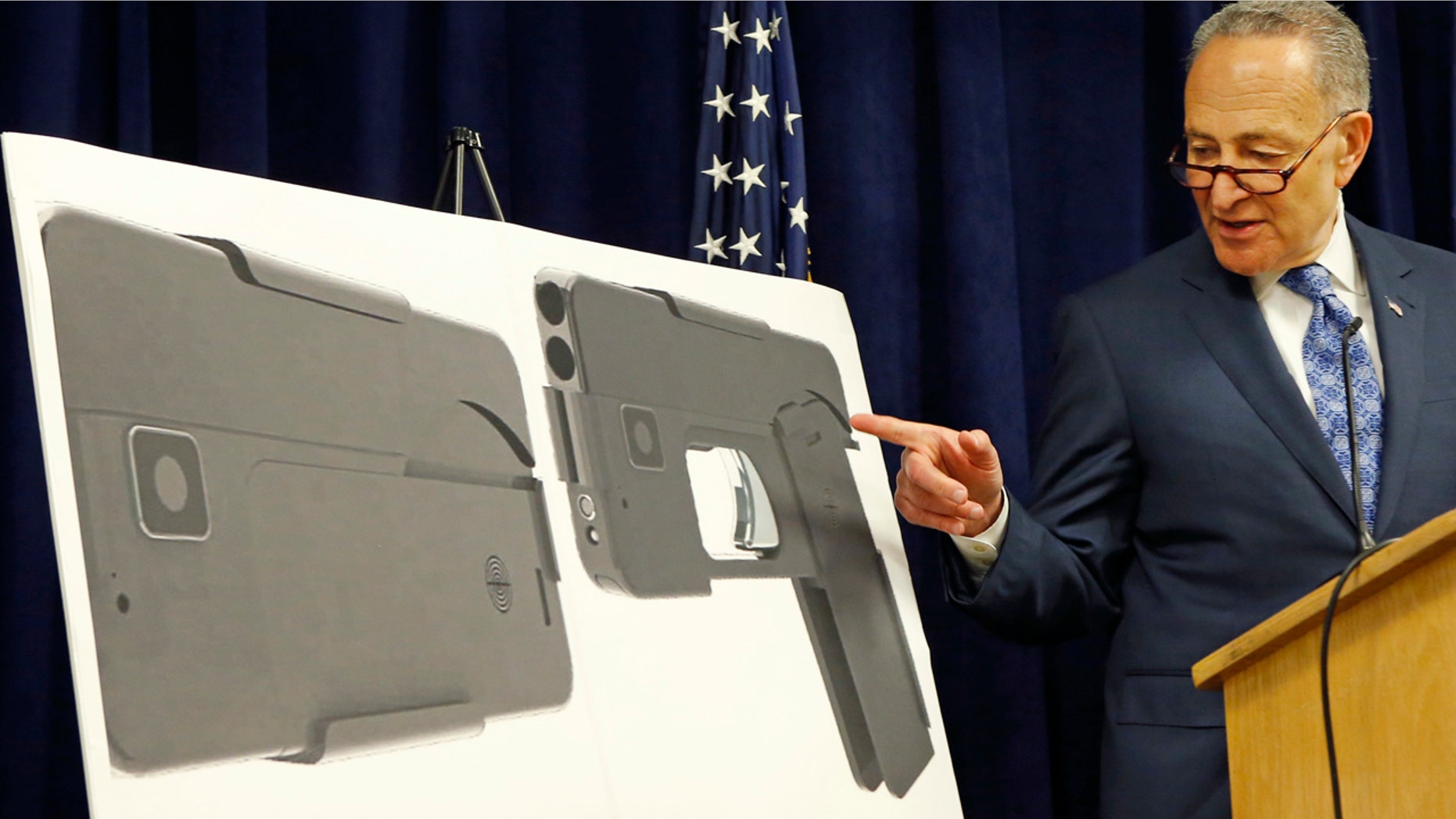 April 4, 2016: U.S. Sen Charles Schumer, (D-New York), points to photographs of what appears to be a cell phone, but is actually a handgun, during a press conference in his office