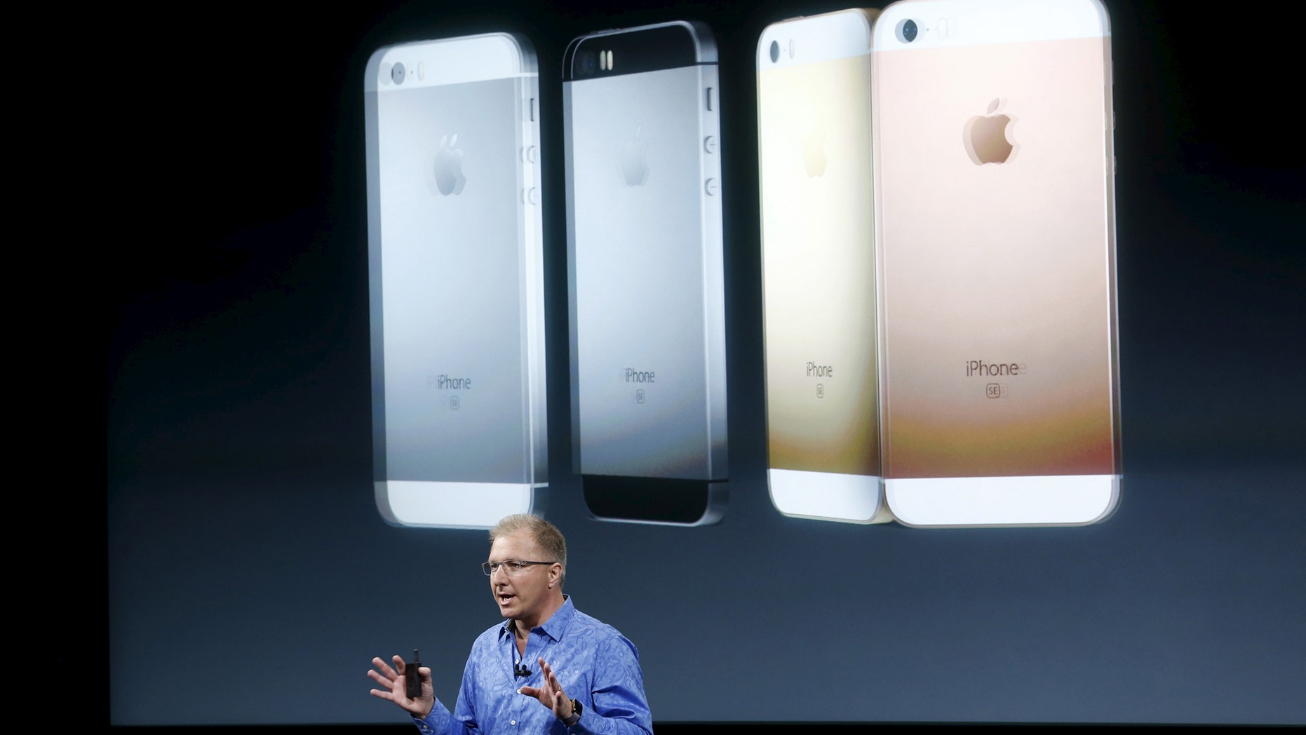 Apple Vice President Greg Joswiak introduces the iPhone SE during an event at the Apple headquarters in Cupertino, California, March 21, 2016. REUTERS/Stephen Lam/File Photo - RTX2BV86