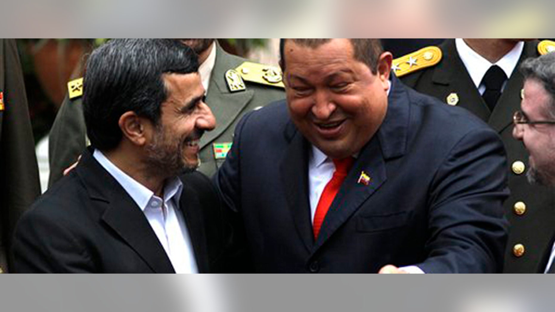 Iran's President Mahmoud Ahmadinejad, left, shares a laugh with Venezuela's President Hugo Chavez upon his arrival at Miraflores presidential palace in Caracas, Venezuela, Monday, Jan. 9, 2012. Ahmadinejad visited with Chavez as tensions rose with the U.S. over Tehran's nuclear program and a death sentence against an American man convicted of working for the CIA. Venezuela is the first leg of a four-nation tour that will also take Ahmadinejad to Nicaragua, Cuba and Ecuador. (AP Photo/Ariana Cubillos)