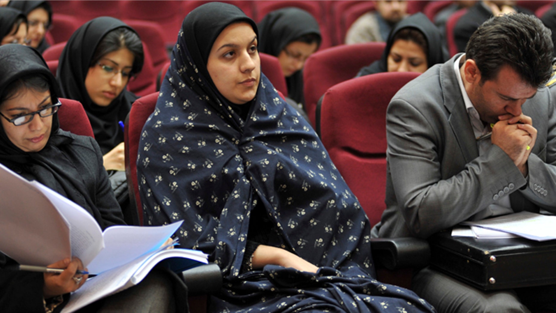 In this picture taken on Dec. 15, 2008, Iranian Reyhaneh Jabbari, center, sits while attending her trial in a court in Tehran, Iran. Jabbari was hanged on Saturday, Oct. 25, 2014, who was convicted of murdering a man she said was trying to rape her, the official IRNA news agency reported.