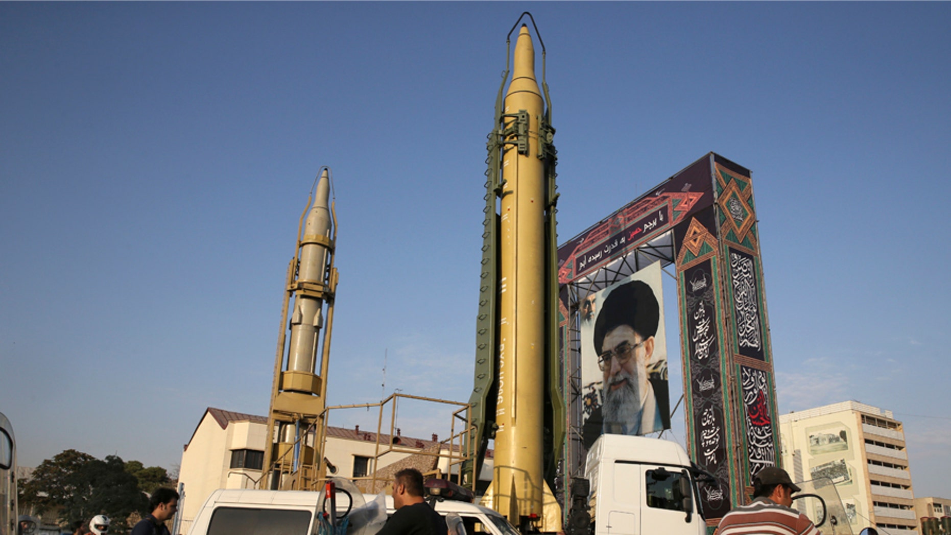 A Ghadr-H missile, center, a Sejjil missile and a portrait of the Iranian Supreme Leader Ayatollah Ali Khamenei are on display for the annual Defense Week, marking the 37th anniversary of the 1980s Iran-Iraq war, at Baharestan Sq. in Tehran, Iran, Sunday, Sept. 24, 2017