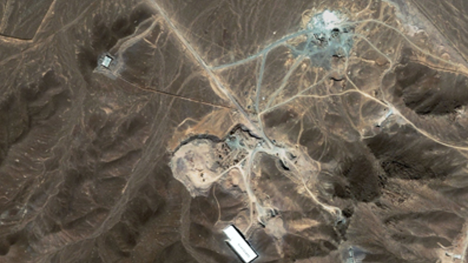 A file satellite image taken Sunday Sept. 27, 2009, provided by DigitalGlobe, shows a suspected nuclear enrichment facility under construction inside a mountain located north of Qom, Iran. Critical nuclear talks between Iran and world powers could begin this week in an atmosphere of impasse.