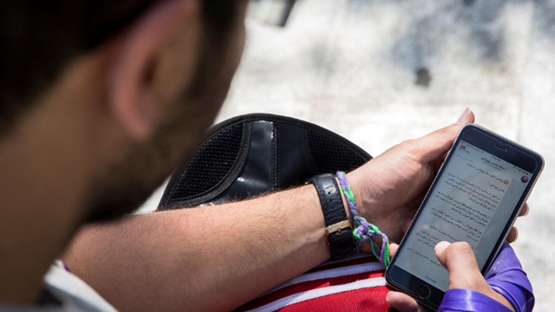 May 17, 2017: A man uses his smartphone to follow election news in Tehran, Iran.