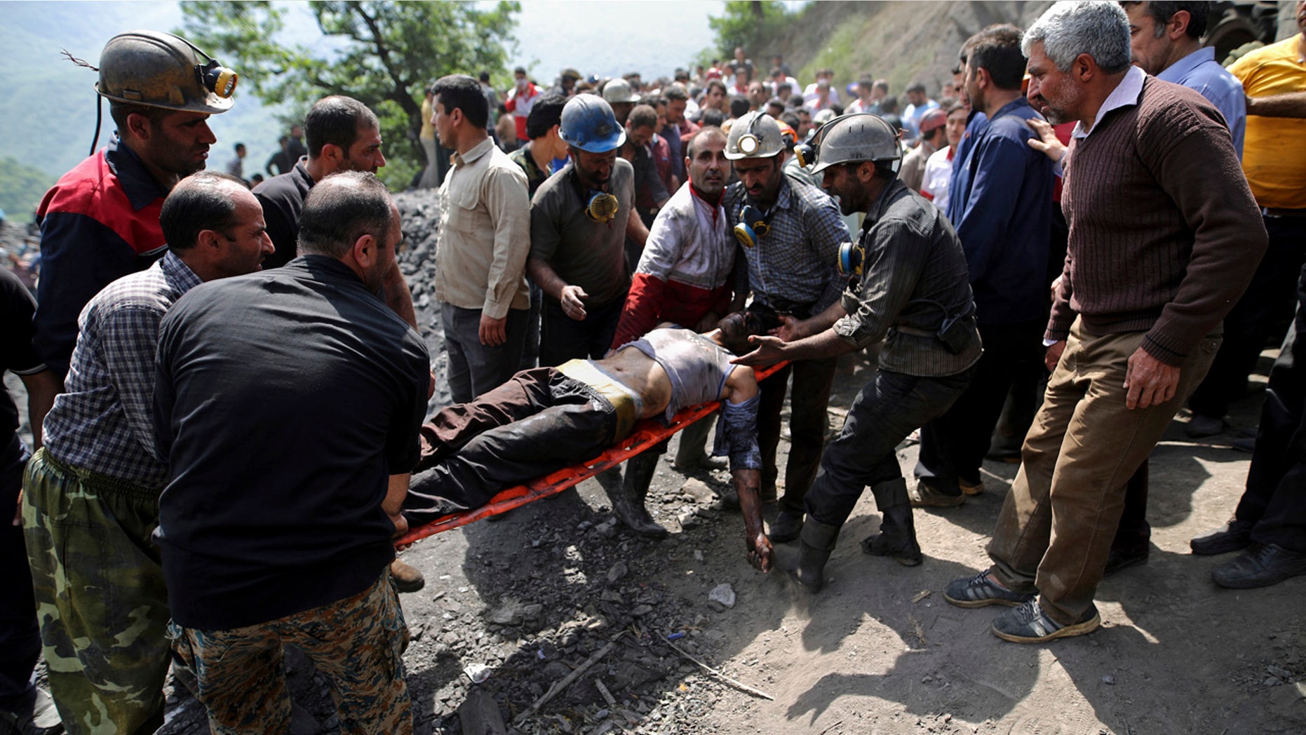 In this picture released by the Tasnim News Agency, miners and rescue personnel carry an injured mine worker after a coal mine explosion, near Azadshahr in northern Iran, Wednesday, May, 3, 2017.
