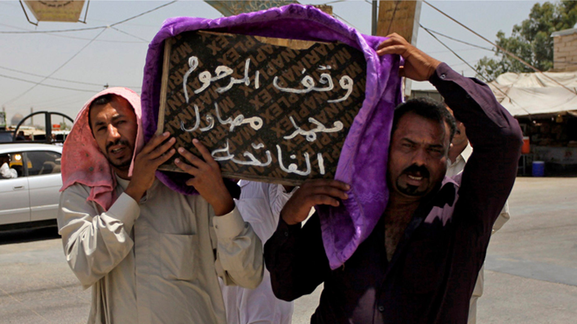 July 1, 2014: Mourners carry the coffin of a victim of violence before his burial in the Shiite holy city of Najaf, 100 miles south of Baghdad, Iraq. Violence has claimed the lives of 2,417 Iraqis in June, making it the deadliest month so far this year, the United Nations said on Tuesday, underlining the daunting challenge the government faces as it struggles to confront Islamic extremists who have seized large swaths of territory in the north and west. Arabic on the coffin reads, "they stood for the late Mohammed Mosawel."