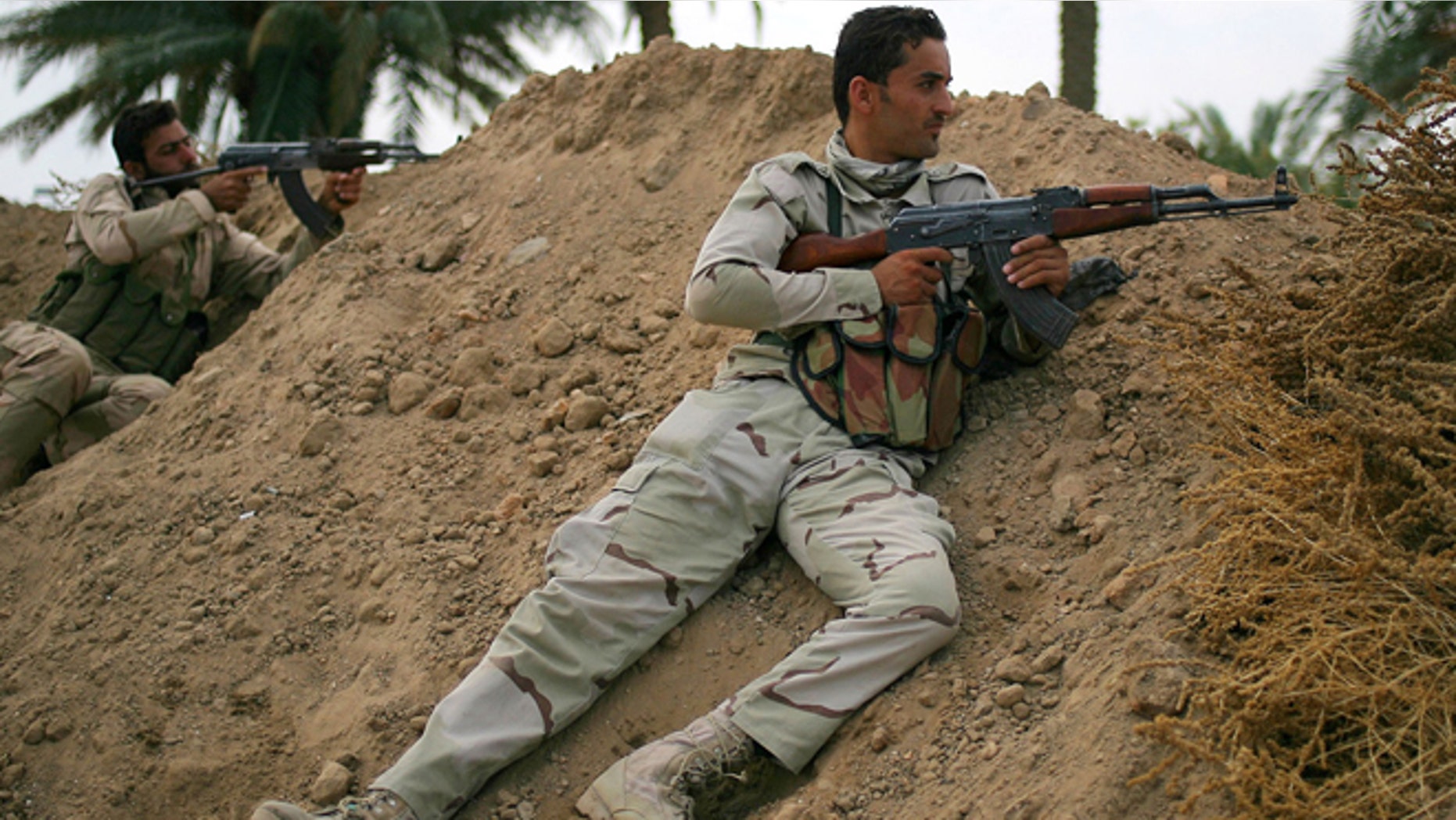 Oct. 27, 2014: In this photo, Iraqi army soldiers aim their weapons on the front line with the Islamic State group in Jurf al-Sakhar, 43 miles south of Baghdad, Iraq.