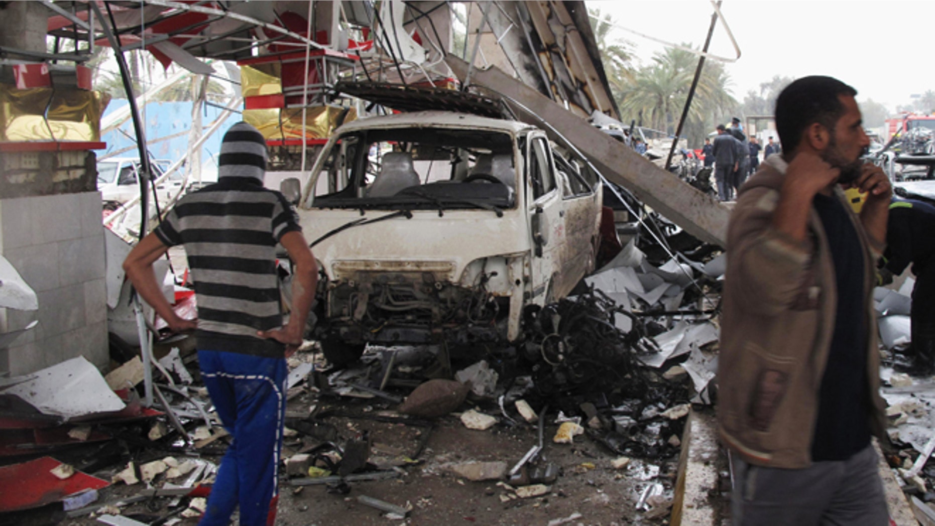 March 9, 2014: Civilians inspect the site of a massive bomb attack in Hillah, about 60 miles south of Baghdad, Iraq. A suicide car bomber set off his explosive-laden vehicle at a security checkpoint in southern Iraq on Sunday, killing and wounding scores of people, police said. Iraq has seen a spike in violence since last April, with the death toll climbing to its highest levels since the worst of the country's sectarian bloodletting in 2006-2008.