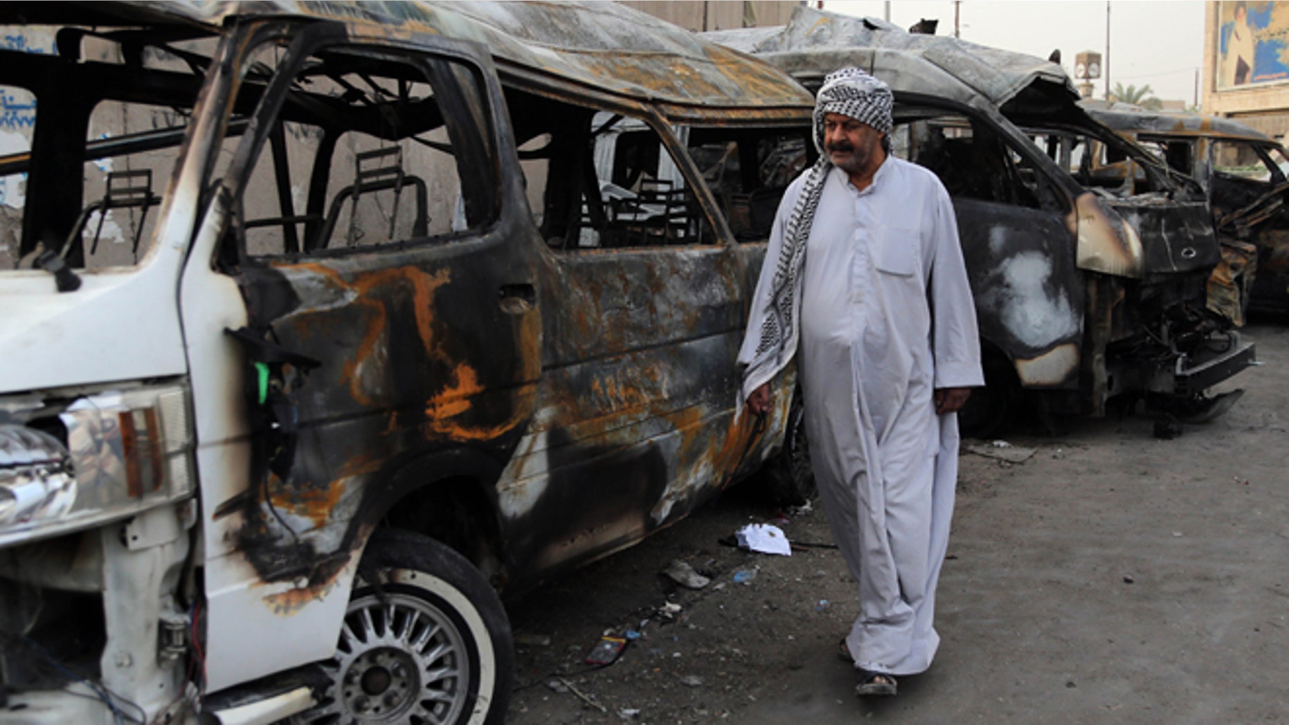 Oct. 12, 2014: A man looks at the site of a car bomb attack in the Shula neighborhood of Baghdad, Iraq.