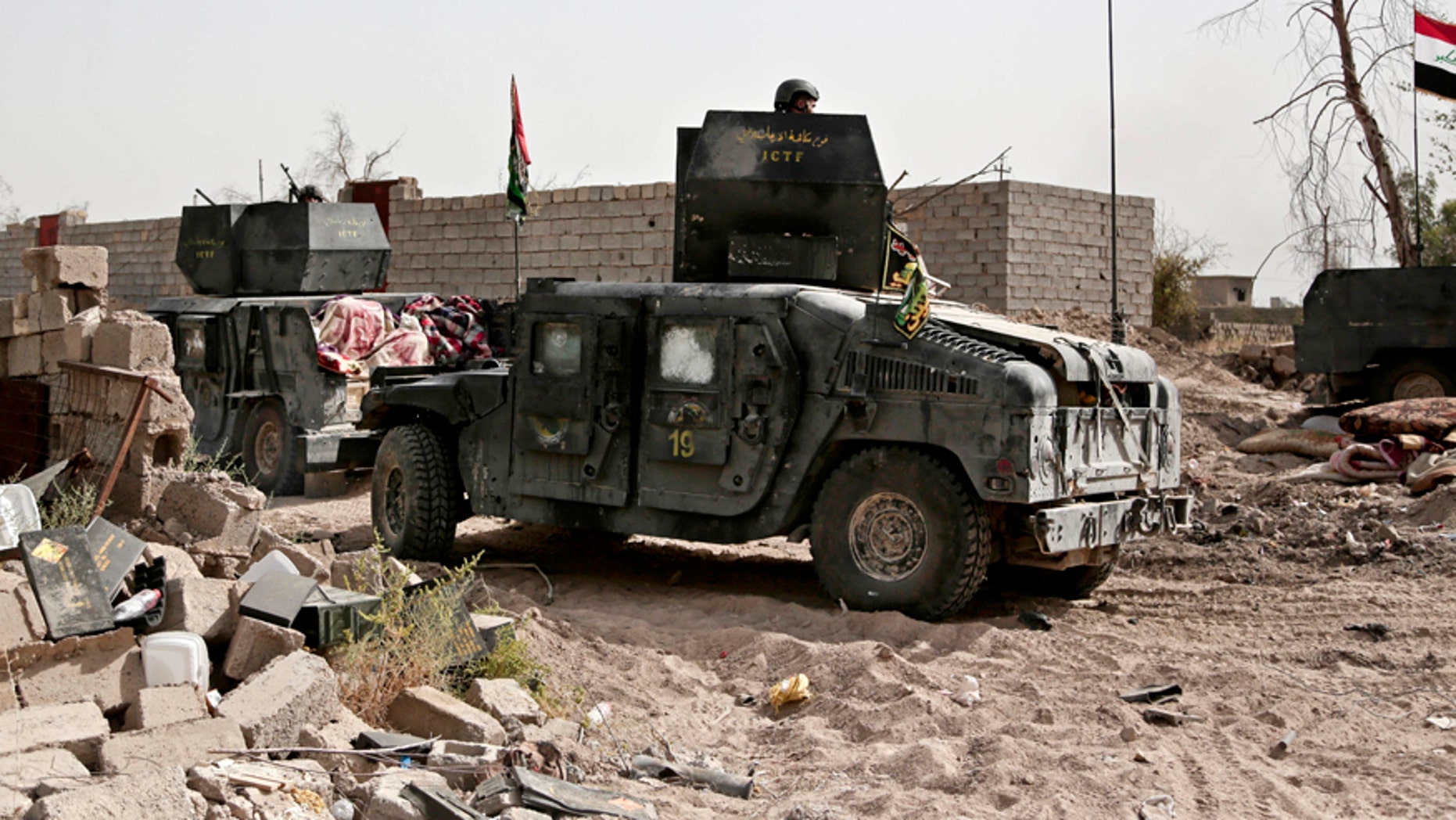 June 8, 2016: Humvees stage on the the edge of the Shuhada neighborhood in Islamic State-held Fallujah, Iraq, just before Iraqi special forces pushed into the district.