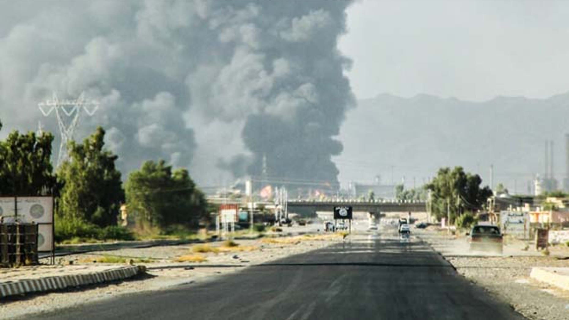 July 31, 2014: In this file photo, a column of smoke rises from an oil refinery in Beiji, some 155 miles north of Baghdad, Iraq, after an attack by Islamic militants. (AP)