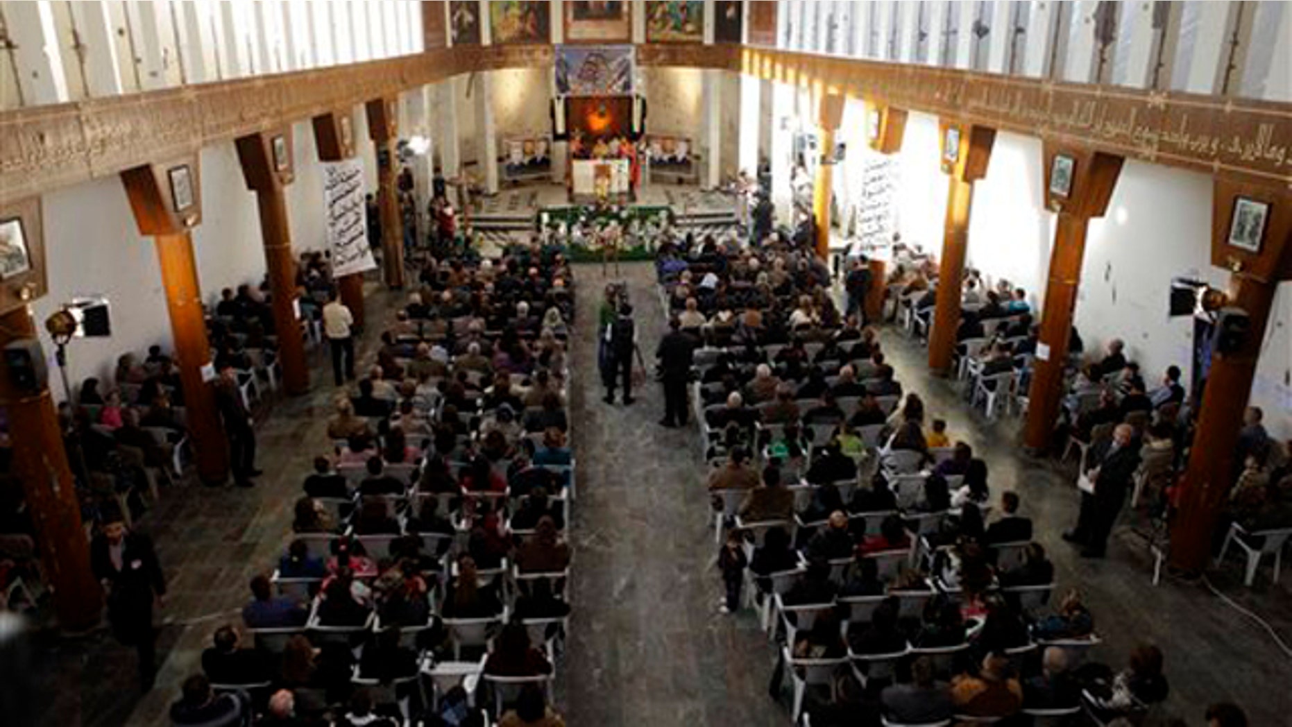 Dec. 25, 2010: Iraqi Christians attend a Mass at Our Lady of Salvation church in Baghdad, Iraq. Iraqi Christians are marking a somber Christmas in the face of repeated violence by militants intent on driving their beleaguered community from Iraq.