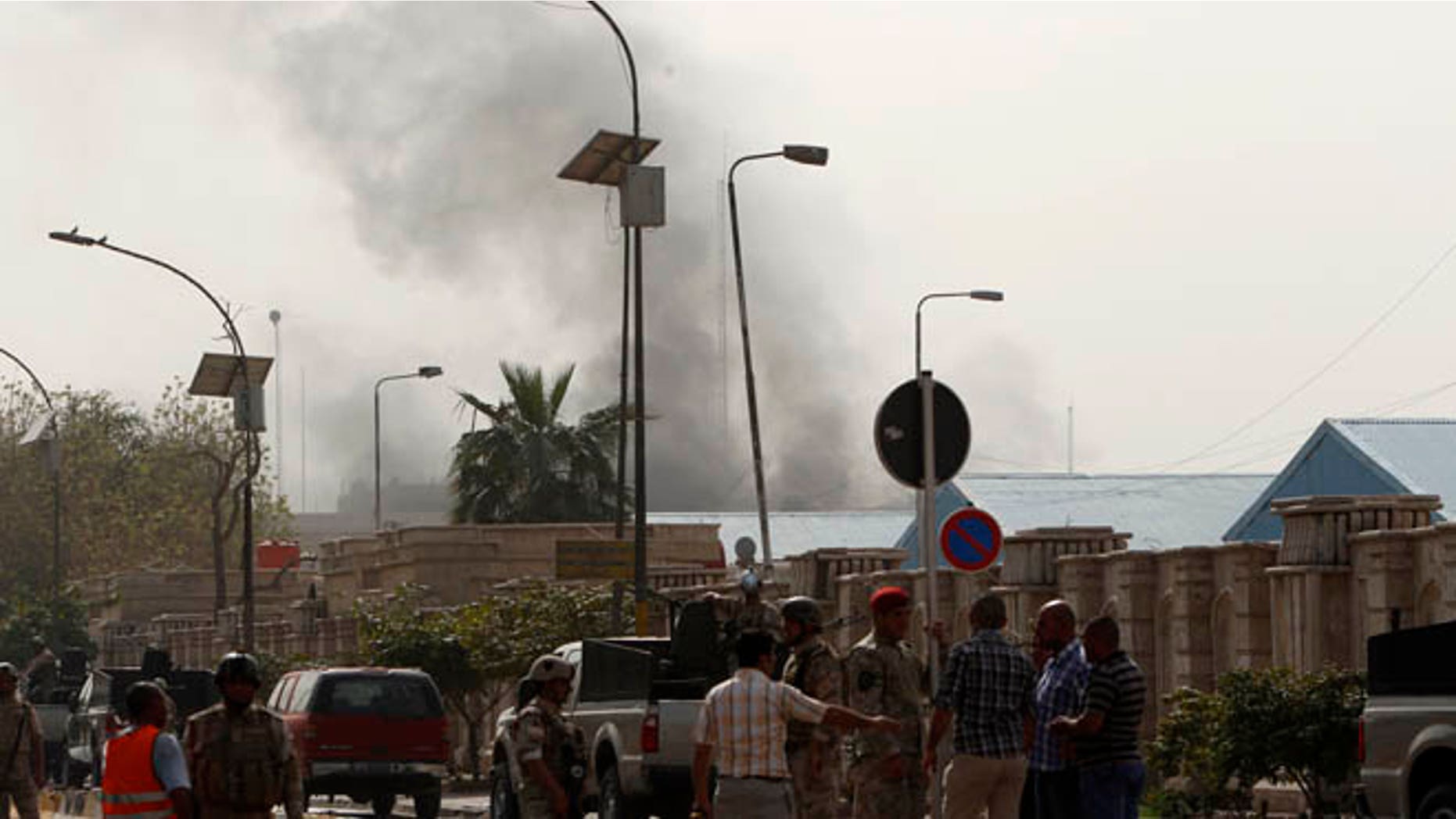 March 14, 2013: Members of the Iraqi Army gather near the site of a bomb attack at Alawi district in Baghdad. Co-ordinated blasts in the heart of the Iraqi capital Baghdad killed at least 22 people on Thursday, near the heavily fortified Green Zone, where several Western embassies are located, police and medics said.