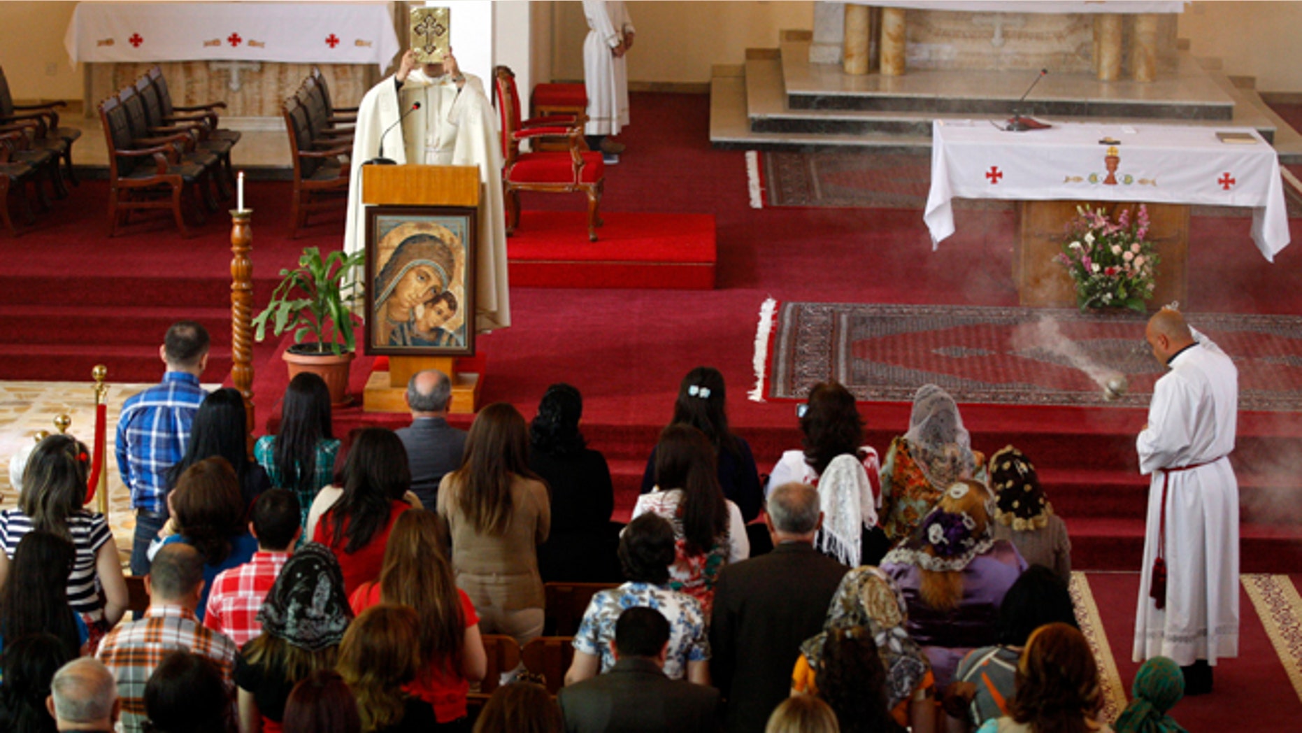 March 31, 2013: Iraqi Christians pray during Easter mass at Mar Youssif Chaldean Church in Baghdad, Iraq. The Chaldean Church is an Eastern Rite church affiliated with the Roman Catholic Church.