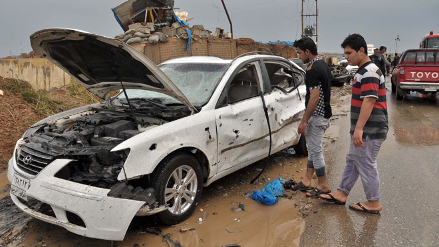April 13, 2014: Iraq civilians inspect the site of a suicide car bombing in the northern town of Dibis, near the city of Kirkuk, 180 miles north of Baghdad, Iraq.