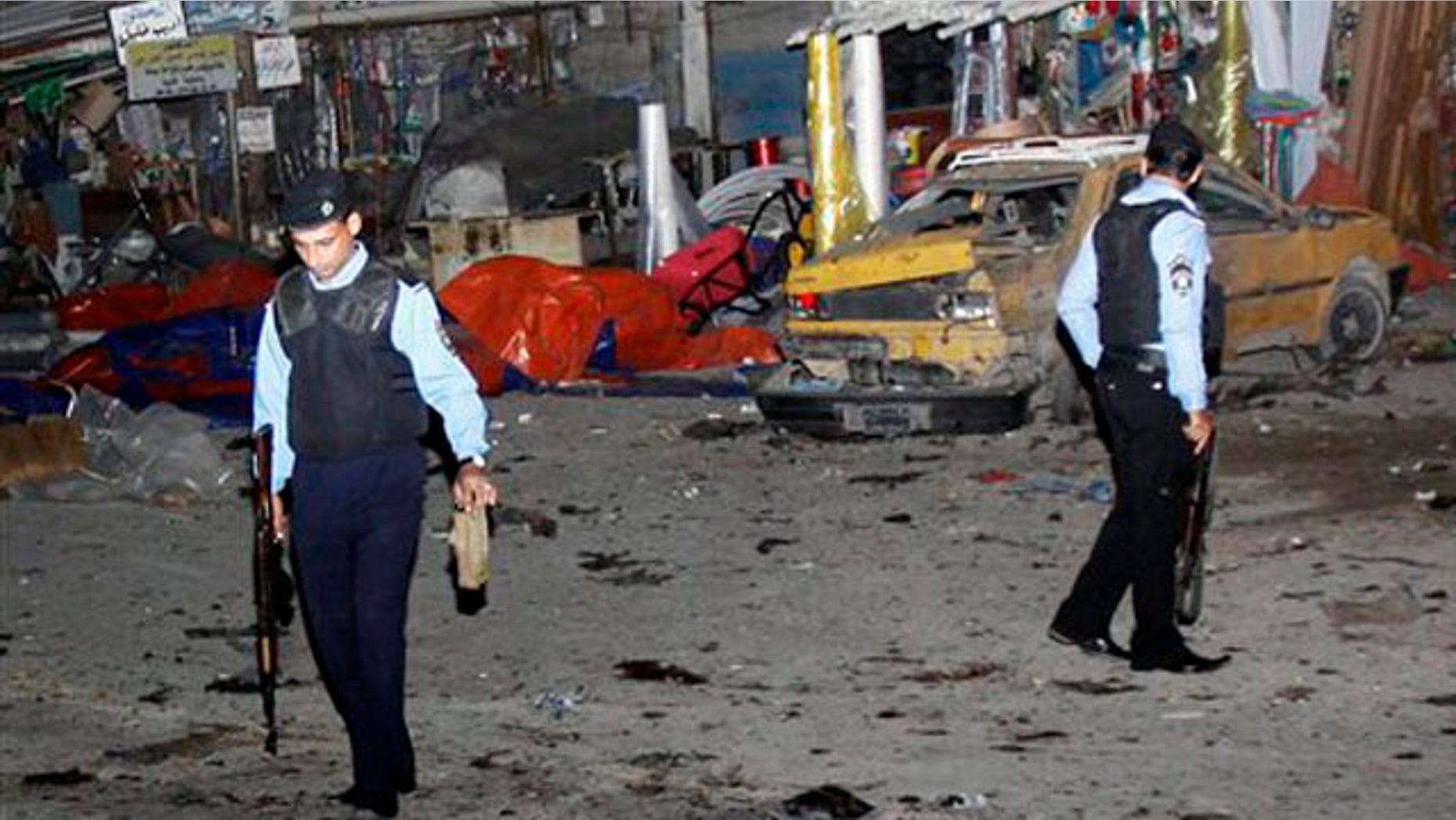 Police inspect the scene of a bomb attack in Basra, 340 miles southeast of Baghdad, Iraq, Thursday, Nov. 24, 2011.