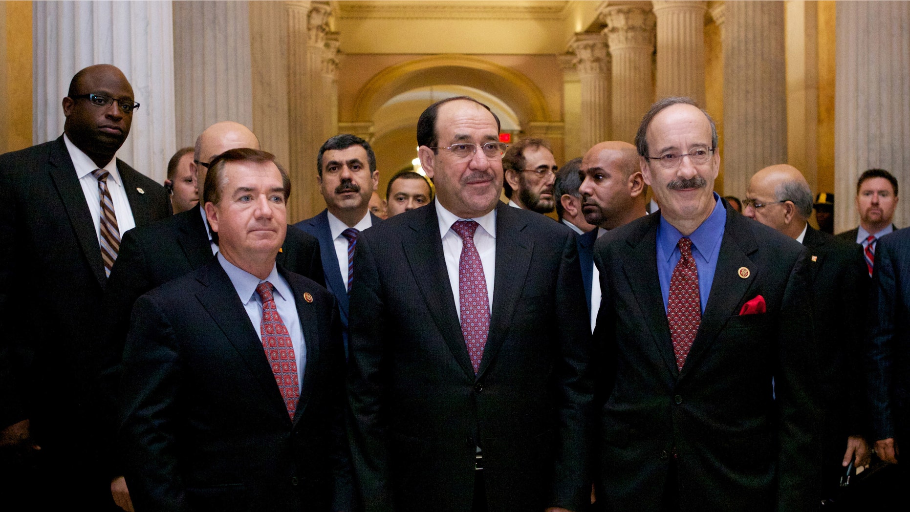 Iraqi Prime Minister Nouri al-Maliki, center, walks with the House Foreign Affairs Committee ranking Democrat Rep. Eliot Engel, D-N.Y., right, and the committee's chairman Rep. Ed Royce, R-Calif. in Washington, Wednesday, Oct. 30, 2013, before their meeting.