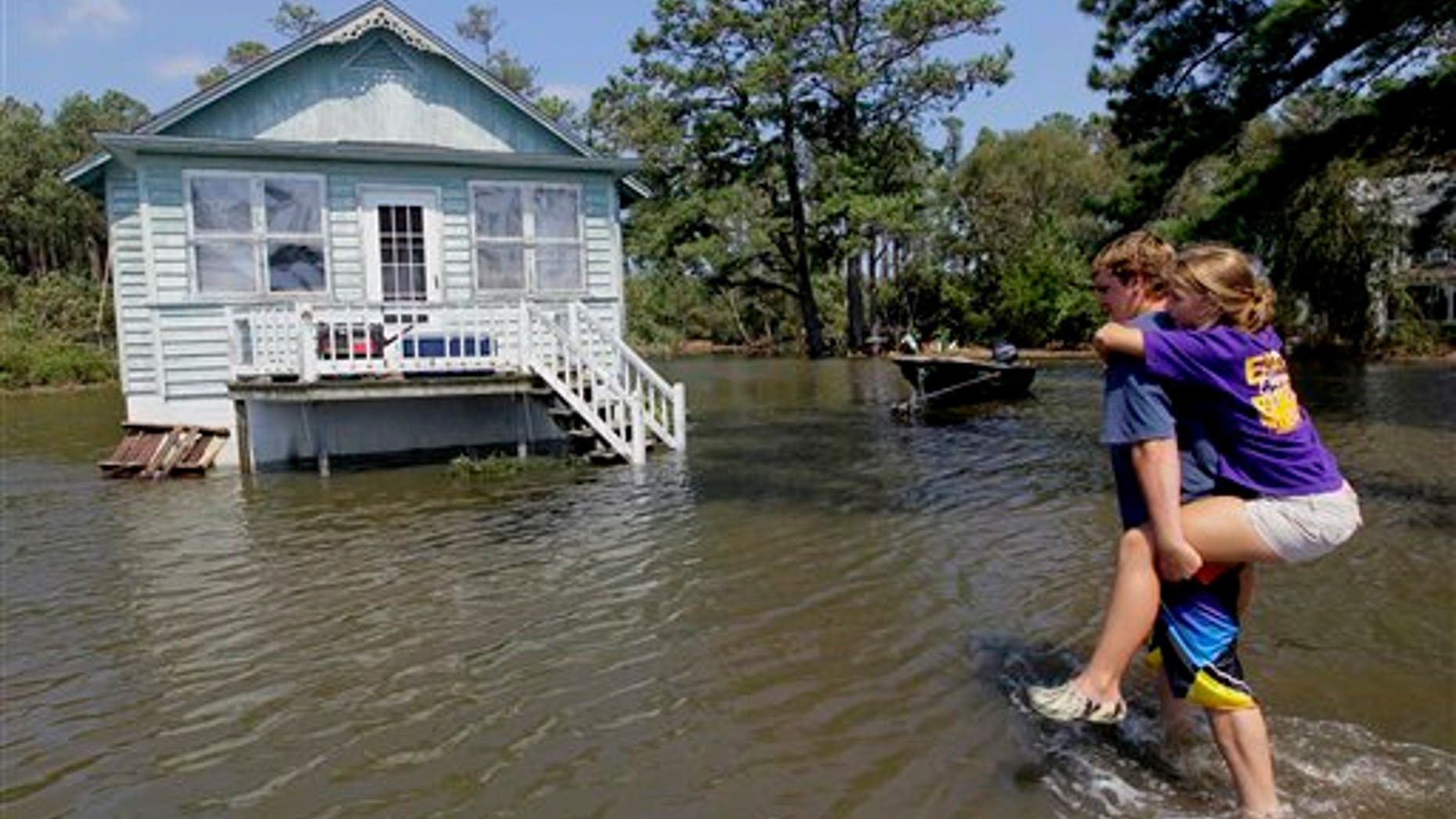 Aug. 28: Residents of Stumpy Point, N.C. make their way into their flooded home following the effects of Hurricane Irene. Flood waters rose all across New Jersey on Sunday, closing roads from side streets to major highways as Hurricane Irene weakened and moved on, leaving 600,000 homes and businesses without power.