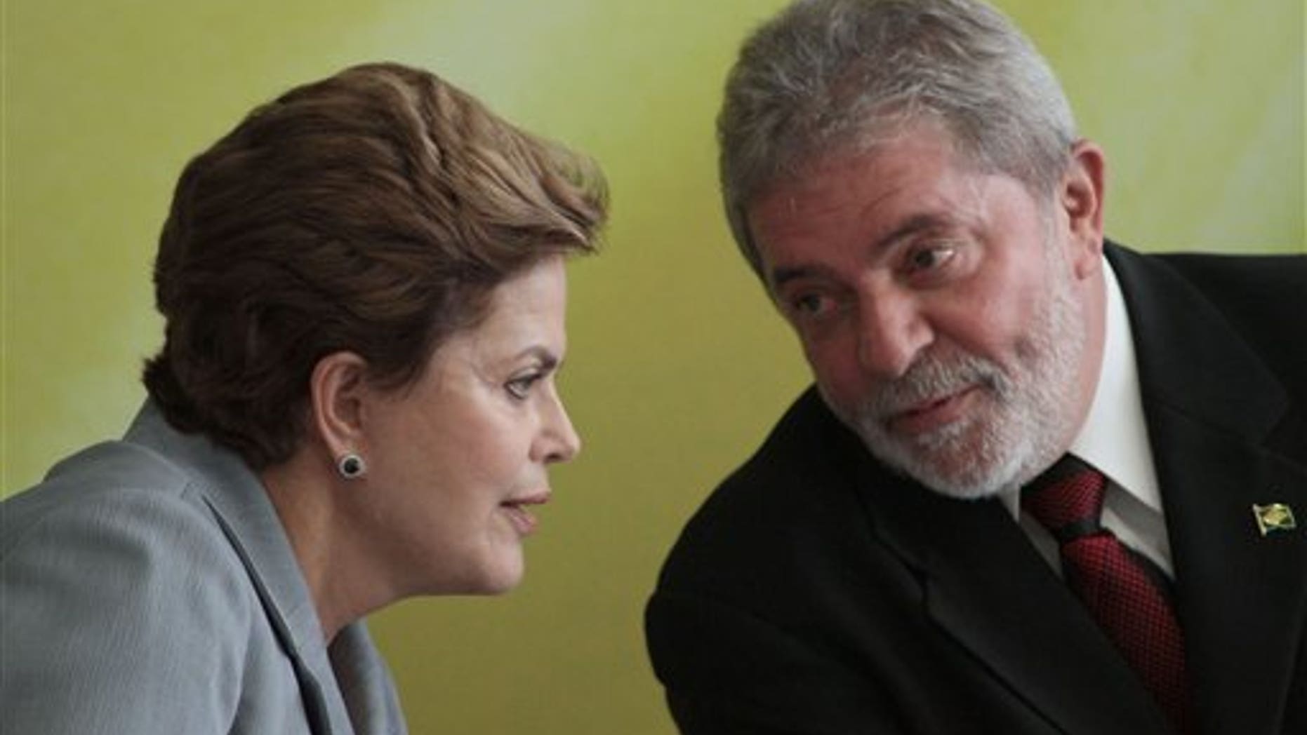 Brazil's President-elect Dilma Rousseff talks with President Luiz Inacio Lula da Silva during an event where Lula da Silva spoke of his eight-year administration at the presidential palace in Brasilia, Brazil, Wednesday Dec. 15, 2010. (AP Photo/Eraldo Peres)