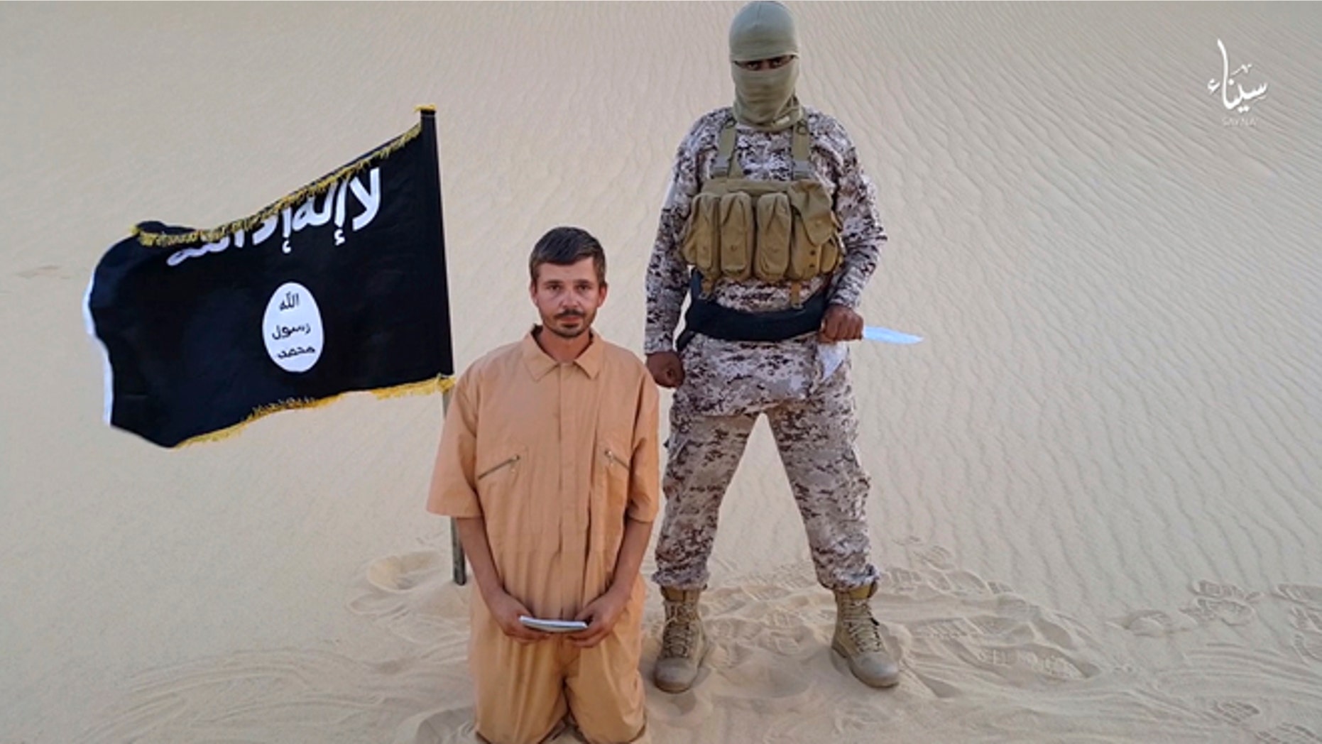 Aug. 5. 2015: This image made from a militant video posted on a social media website, which has been verified and is consistent with other AP reporting, purports to show a militant standing next to another man who identifies himself as 30-year-old Tomislav Salopek, kneeling down as he reads a message at an unknown location.